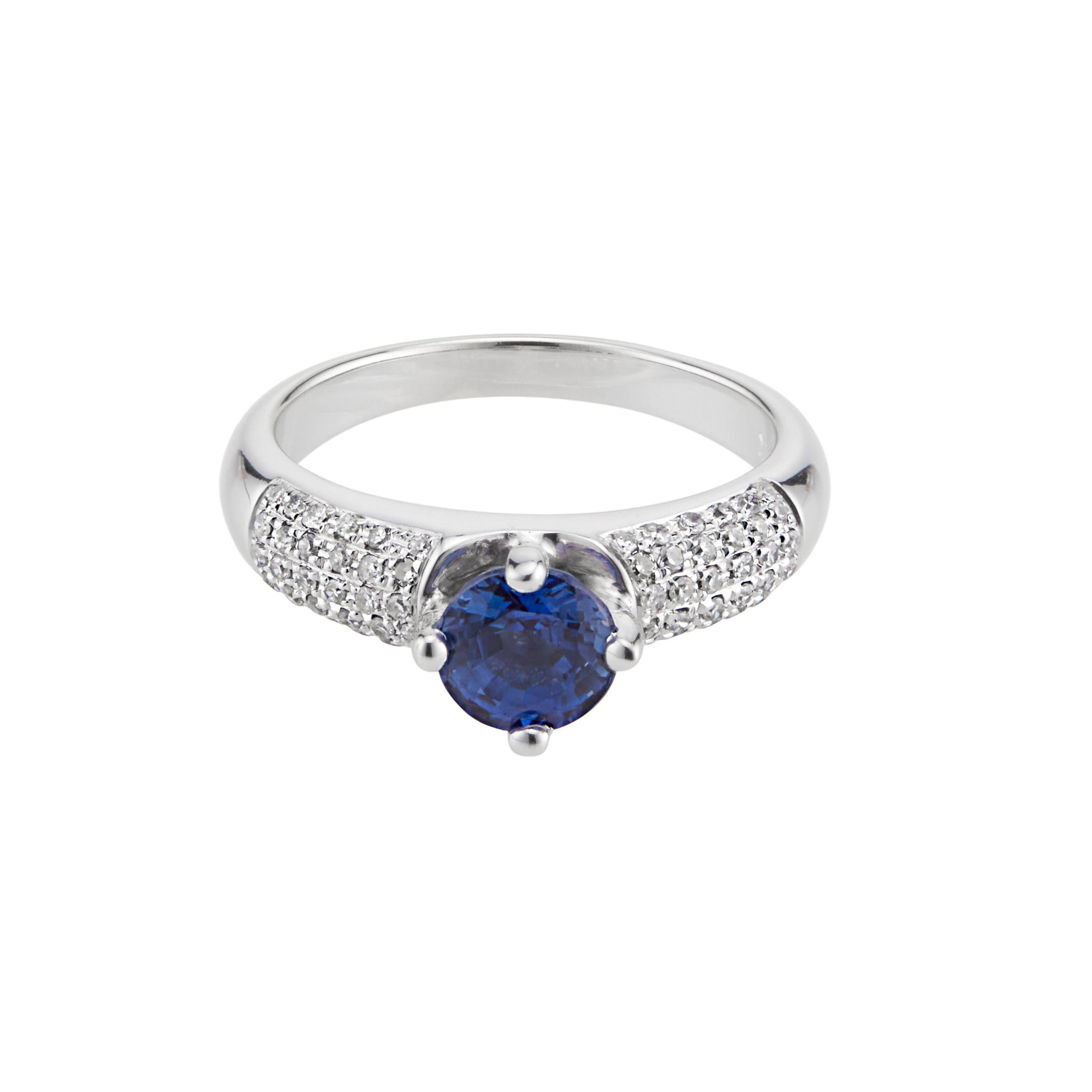 Sapphire and diamond engagement ring. Round bright blue center  sapphire set in diamond pave white gold engagement setting.  

1 round blue sapphire, SI approx. 1.00ct
60 single cut diamonds, I SI I approx.. .30cts
Size 6 and sizable 
14k white gold