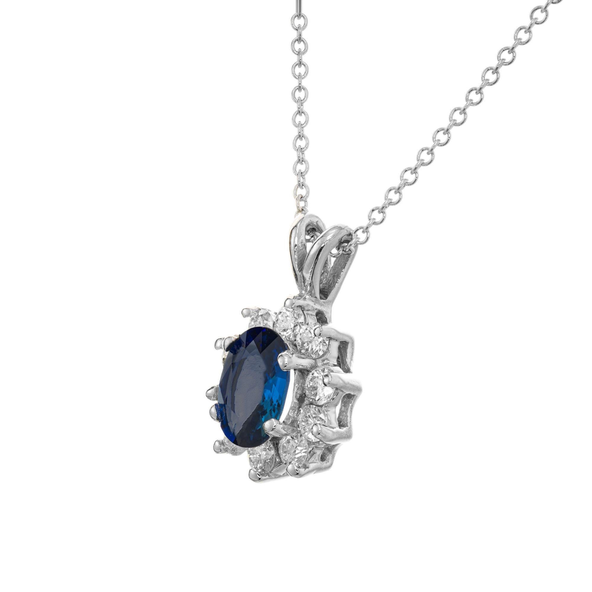 Cornflower blue Sapphire and diamond pendant necklace. Oval sapphire with a halo of 10 round ideal full cut diamonds in 18k white gold. 17.50 inch chain. 

2 cornflower blue oval Sapphire, approx. total weight 1.00cts, VS2, 7 x 5mm, natural color