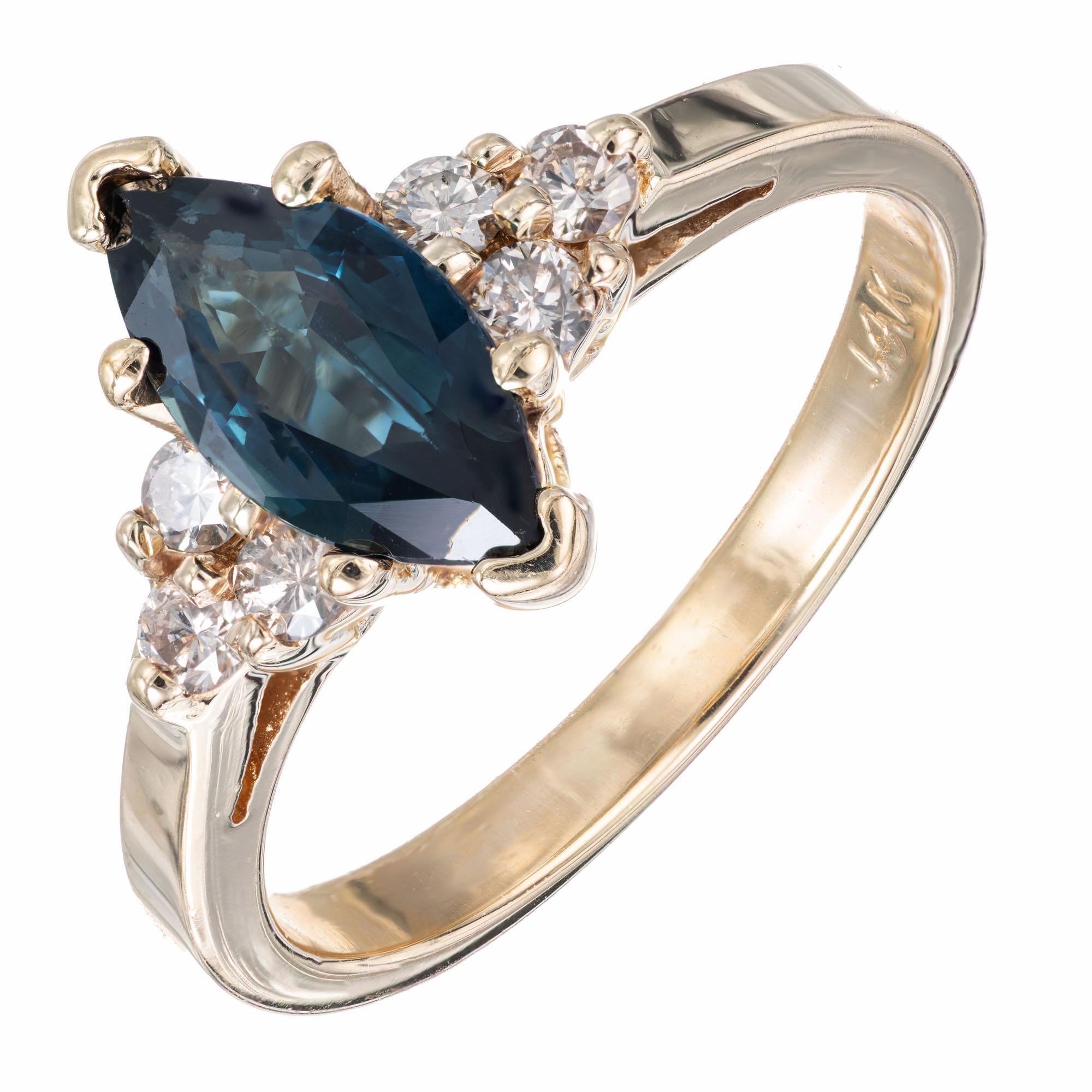 Sapphire and diamond engagement ring. 1.00 carat marquise center sapphire set in a 14k yellow gold setting with 6 accent diamonds.  

1 marquise cut blue sapphire, SI approx. 1.00ct
6 round diamonds, J-K SI approx. .18cts
Size 5.75 and sizable 
14k