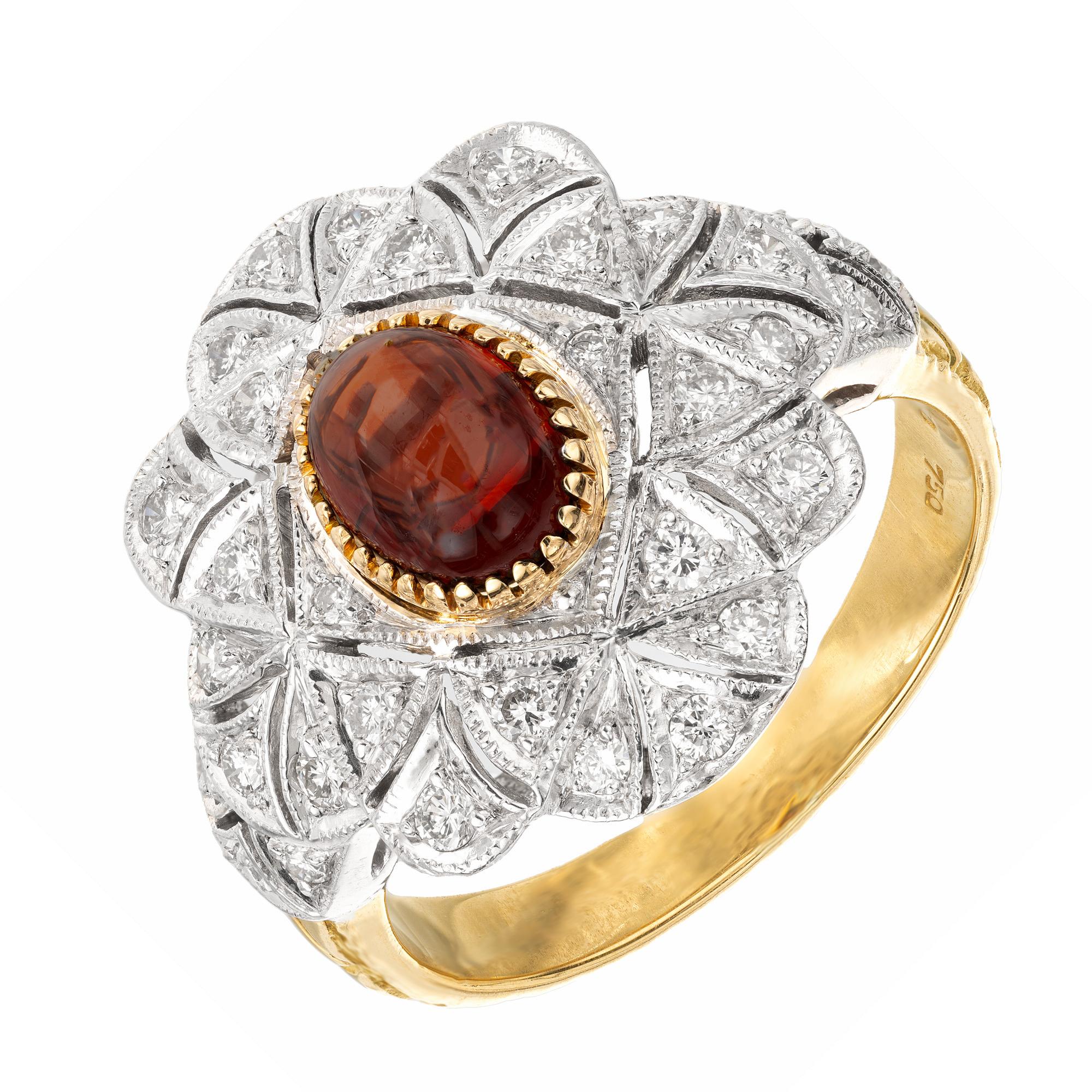 Victorian style garnet and diamond cluster ring. Orange and red cabochon oval 1.00ct garnet is the center of this captivating cluster ring. Accented b y 30 round cut diamonds in a cluster style set in a platinum crown. The shank is 18k yellow gold