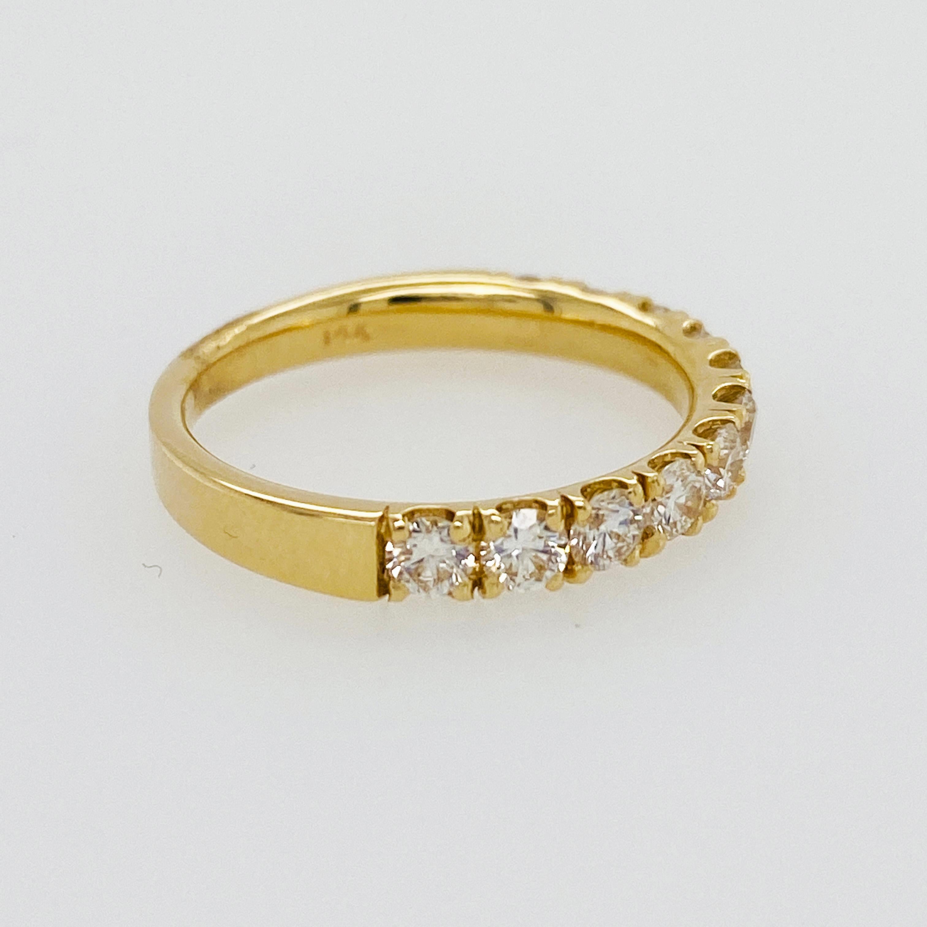 The diamond band has eleven round brilliant diamonds set in four yellow gold prongs. The half diamond band is the perfect size to wear solo or pair it with other stackable rings. The design is classic and sleek with a low profile setting and secure