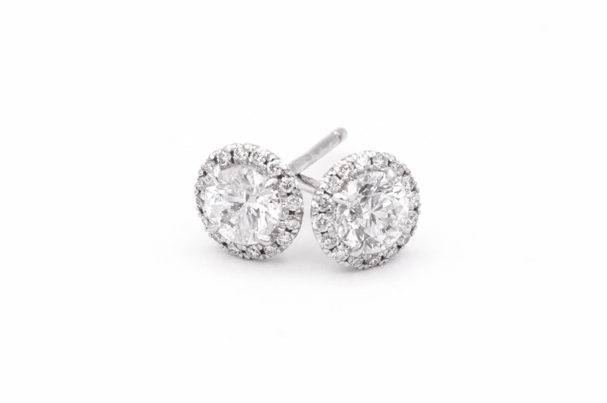 1.00 Carat Diamond Halo Stud earrings in 14K White Gold
Center Diamonds are .85 carats total , F color, SI2 clarity
Surrounded by 32 diamonds weighing an additional .15 cts. 
Total diamonds weight is 1.00 cts 
Has the look of 1 carat each diamonds
