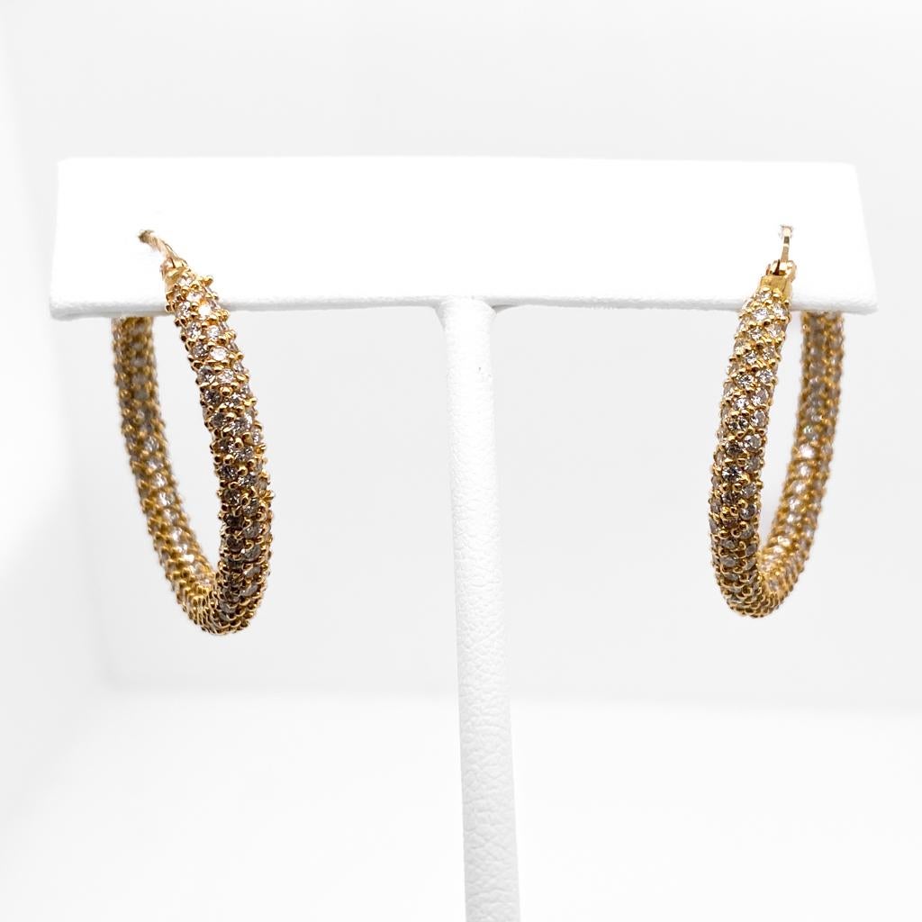 From any angle, these gorgeous 14 karat yellow gold hoop earrings sparkle. The 4 mm wide hoops have a carpet of pavé set diamonds with a total weight of 1.00 carat. The hoops measure 1.5 inch in diameter... a size that flatters nearly anyone! Adorn