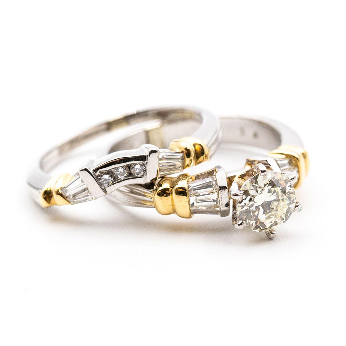 Carefully Crafted in platinum and 18 carat yellow gold is this uniquely designed vintage engagement and wedding bridal ring set flaunting a central 1.00 carat round diamond complimented by six handsome baguette cut diamonds in the band. The
