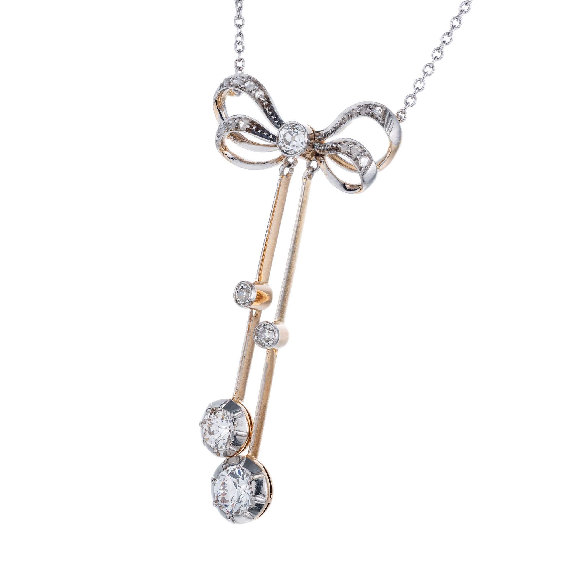 Victorian 1900 Platinum top bow dangle pendant set with old mine and rose cut Diamonds in the Platinum top. 14k yellow gold diamond drops. 18 inch Platinum chain and spring ring. 

5 old mine cut Diamonds, approx. total weight .95cts, H, VS
14 rose