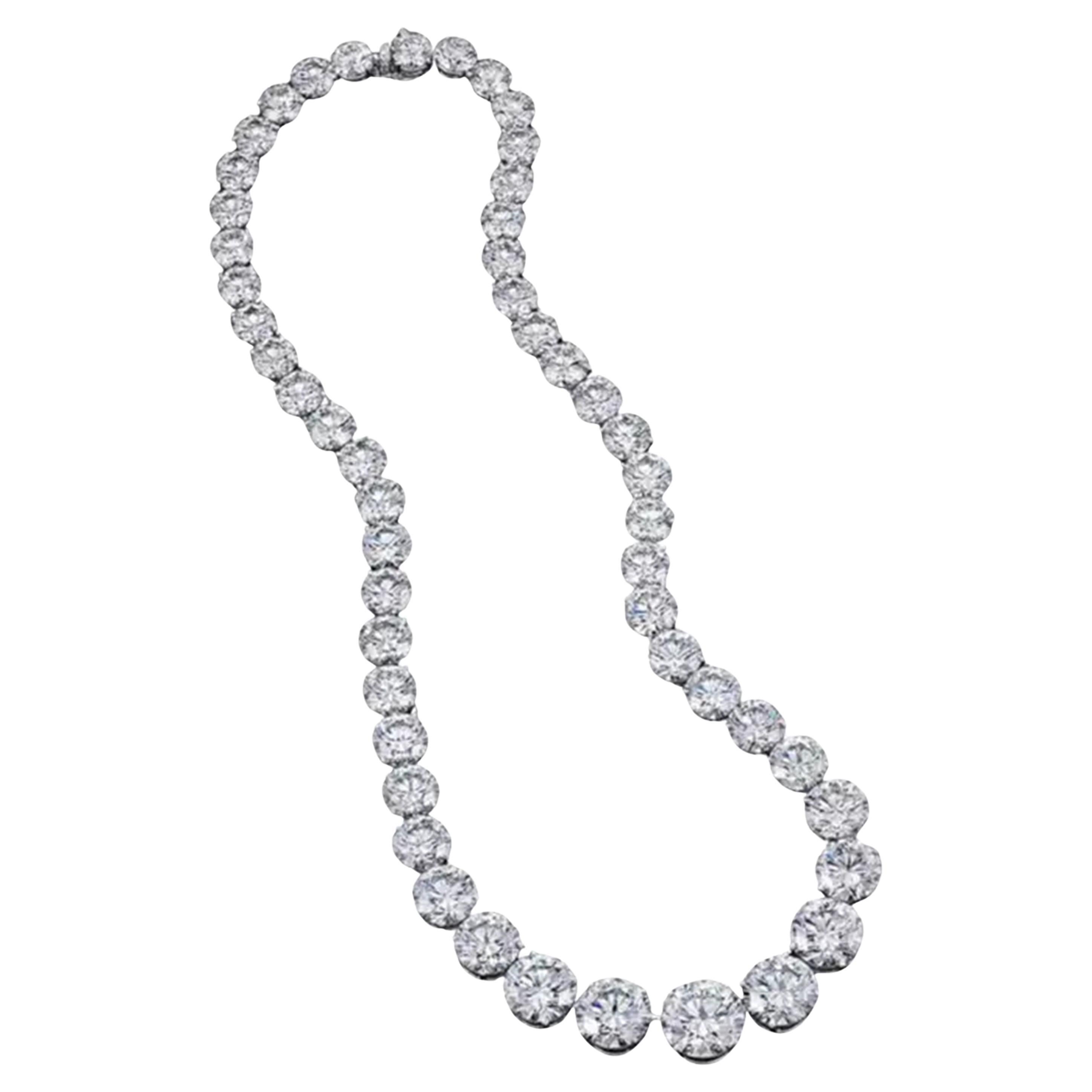 Indulge in unparalleled elegance with this exquisite platinum necklace, a true masterpiece of craftsmanship and luxury. Carefully designed to captivate, this stunning piece features a cascade of graduated round brilliant-cut diamonds, meticulously
