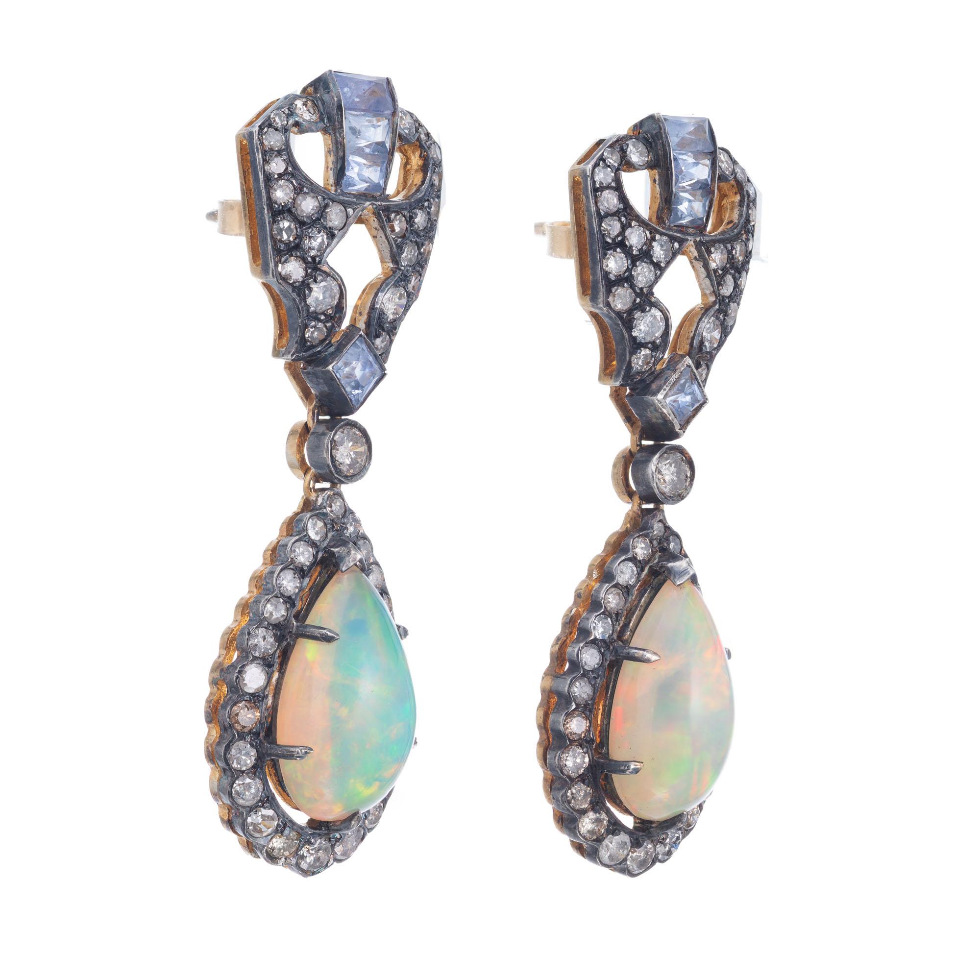 Vintage opal, diamond and sapphire dangle earrings. Pear shaped ovals with halo's of round diamonds set in oxidized silver tops with light blue Ceylon sapphire accents. Gold plated silver back side and 14k gold posts.

98 old round light brown