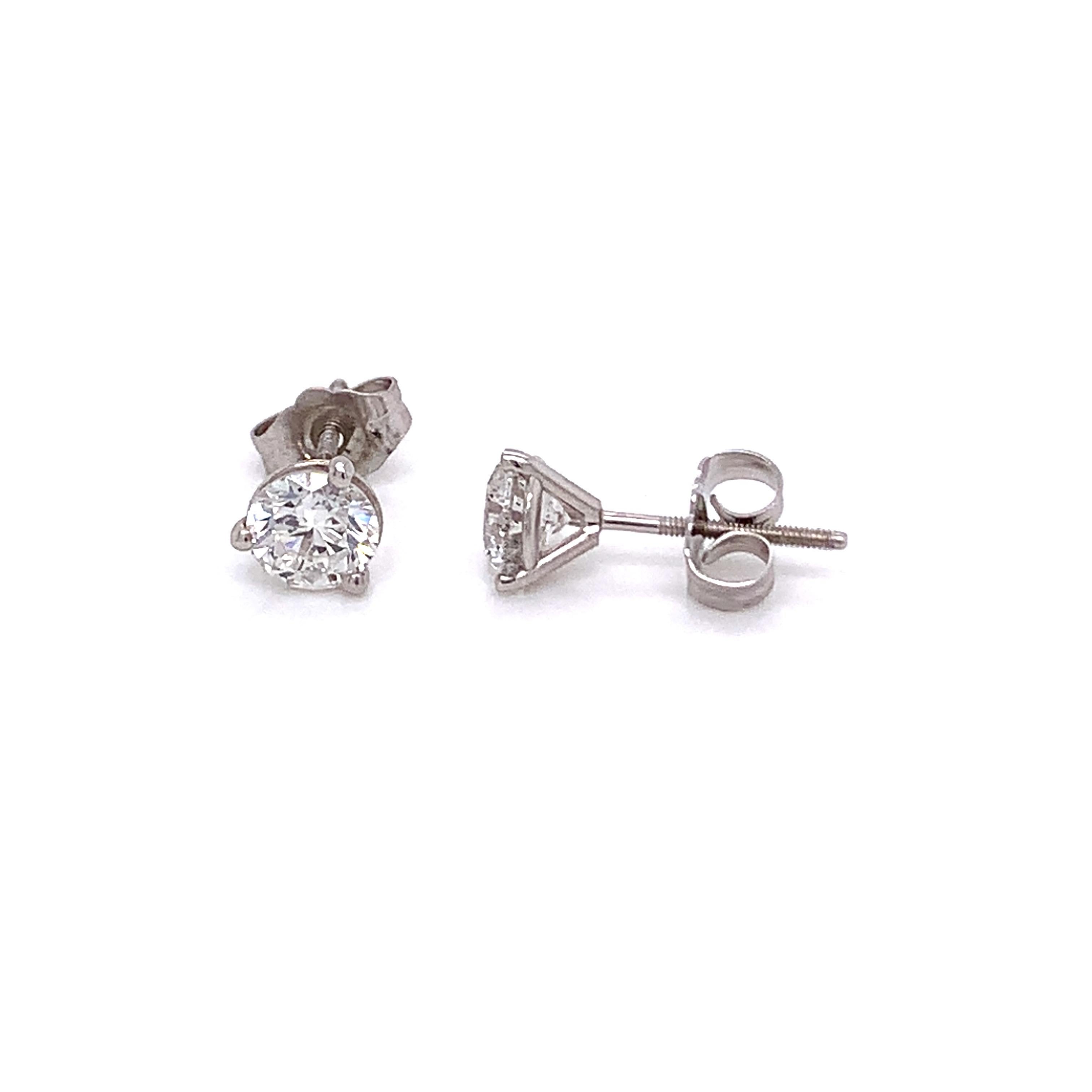Classic Diamond Stud Earrings made with real/natural brilliant cut diamonds. Total Diamond Weight: 1.05cts. Diamond Quantity: 2 round diamonds. Color: F-G. Clarity: SI2-SI3. Mounted on 18kt white gold screw back setting.