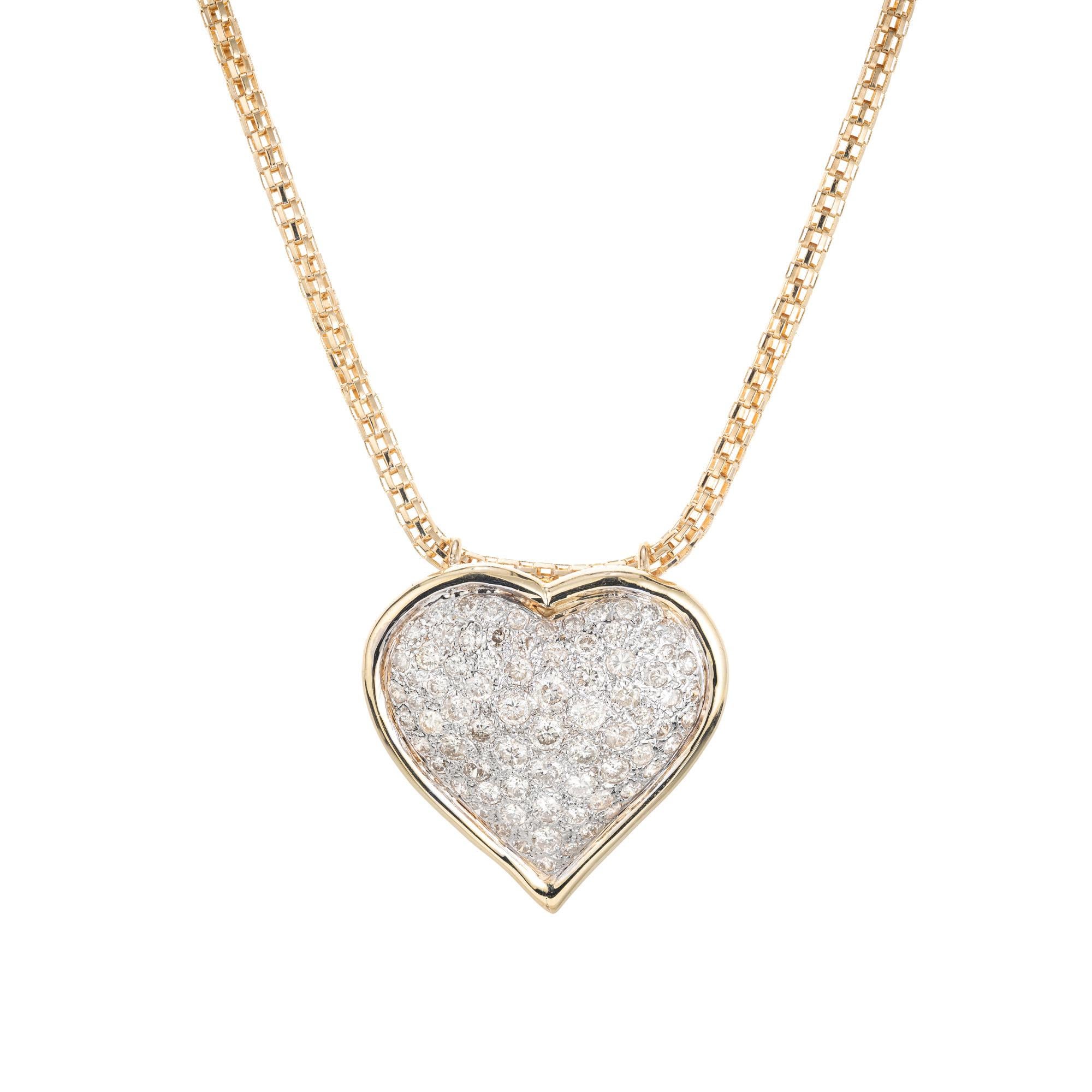 1960's heart shaped diamond pendant necklace. 73 round pave set diamonds totaling 1.00cts, set in 14k white gold with a heart shaped 14k yellow gold frame, attached to an 18 inch yellow gold chain. Substantial in size and elegance. 

73 round