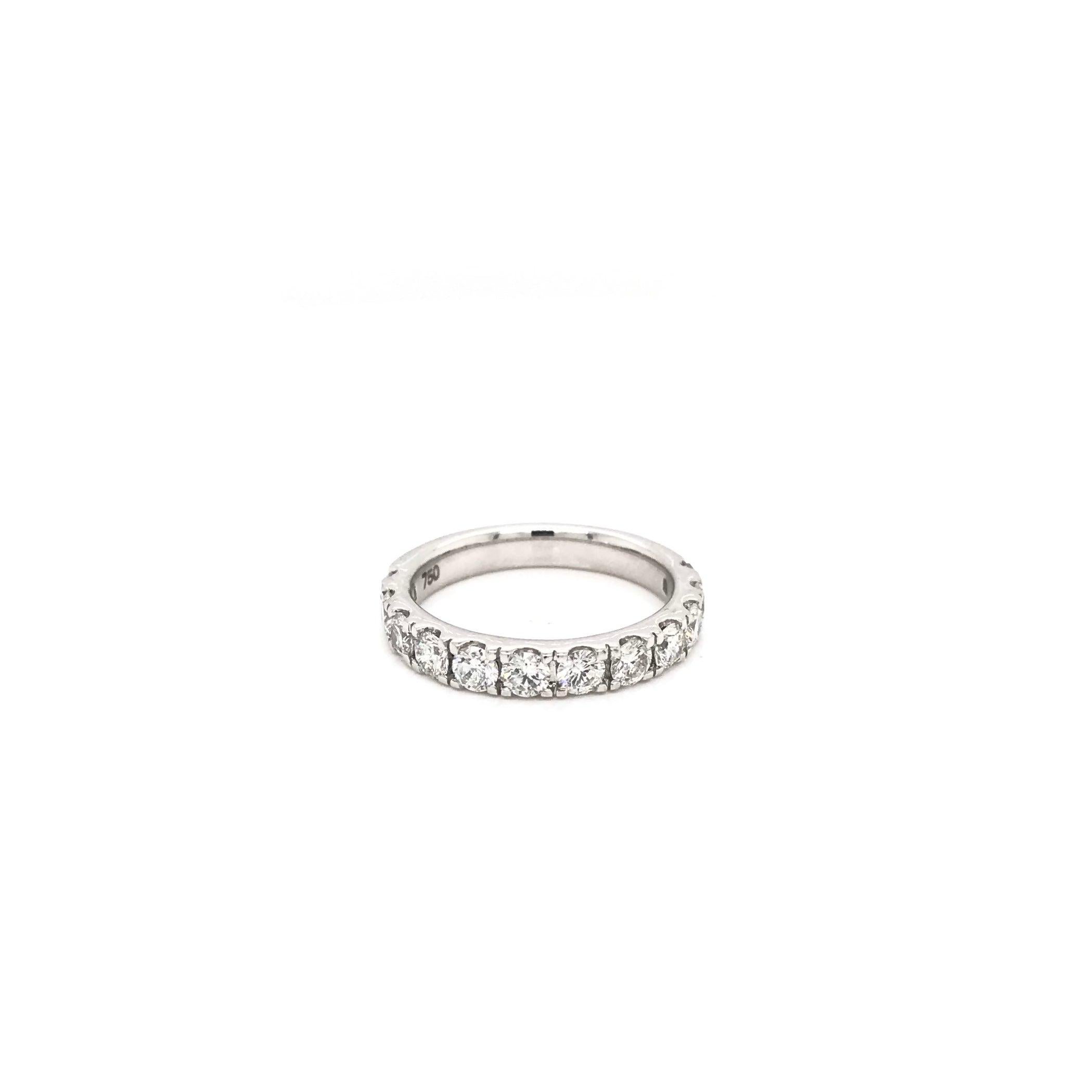This contemporary style diamond band features 11 dazzling diamonds in 14K white gold. The diamonds grade approximately G-H in color and SI1-2 in clarity. This piece has a total combined diamond weight of approximately 1.0 carats. The 18K white gold