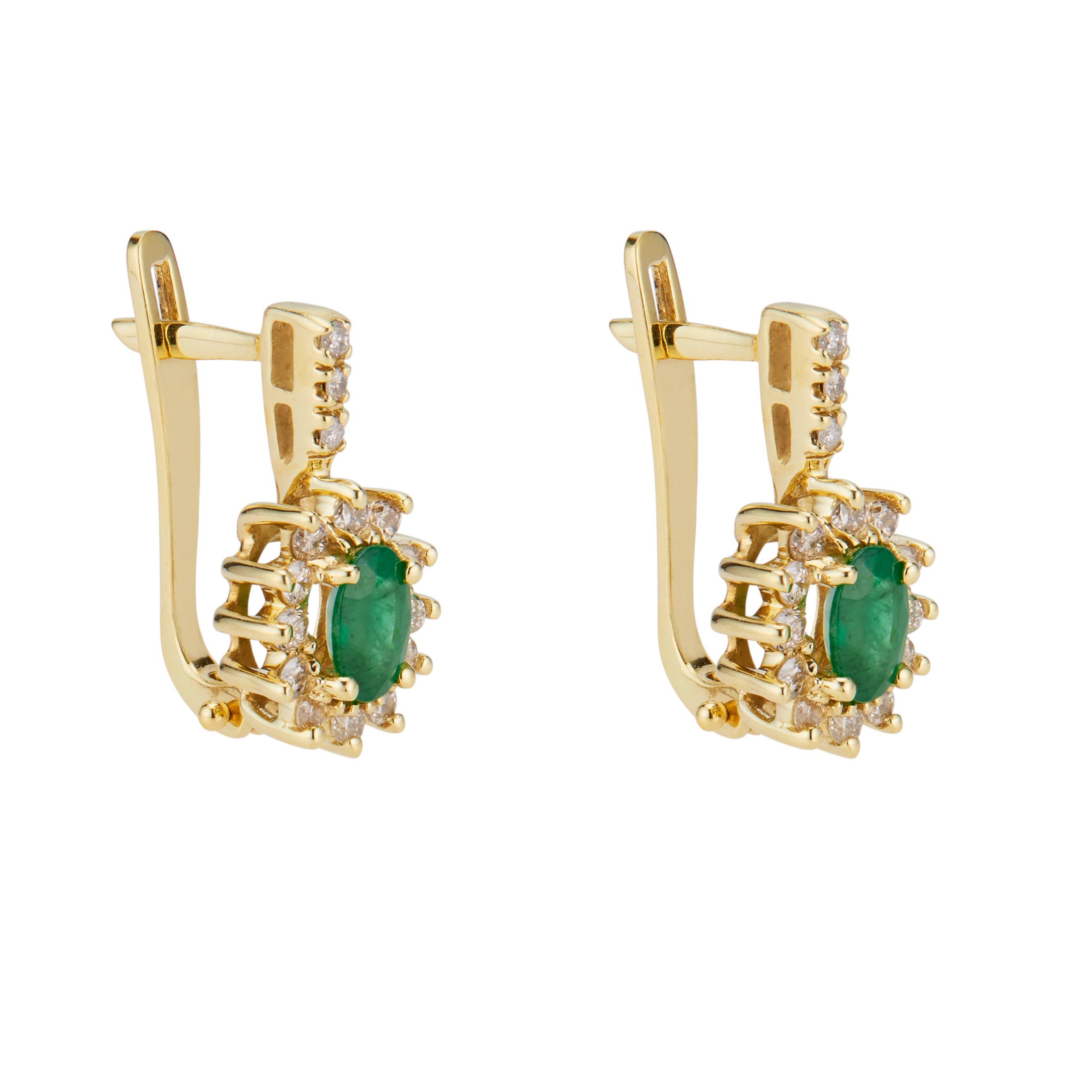 Vintage 1960's oval emerald and diamond earrings. 2 oval emeralds, each with a halo of round brilliant cut diamonds set in 14k yellow gold. Lever backs.  

2 oval green emeralds, approx. 1.00cts
30 round brilliant cut diamonds, I-J SI approx. .38cts