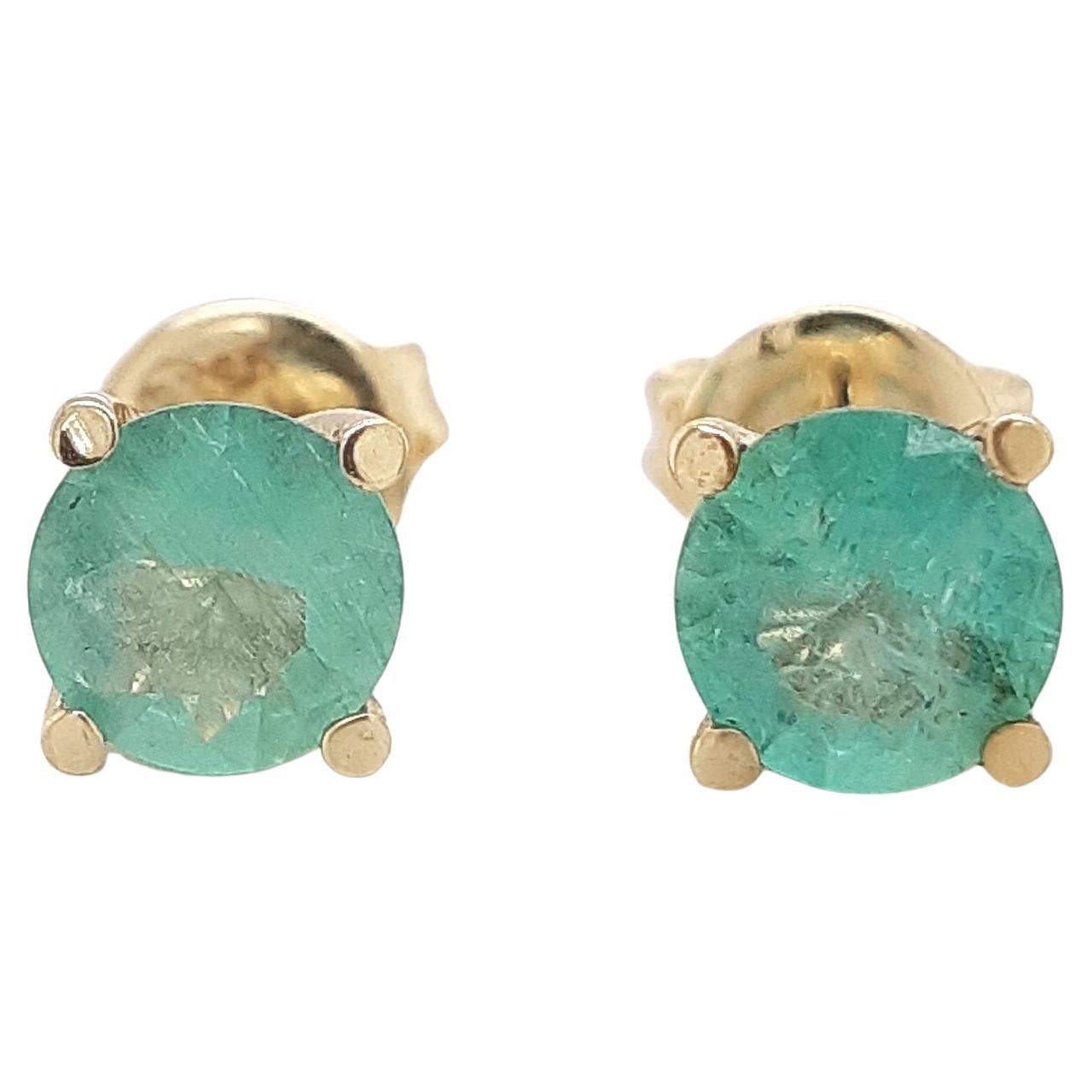 These stunning 14kt emerald stud earrings feature pair of natural round brilliant green emeralds weighing 1.00ct. in total. The earrings are simple, elegant, and classy and its green color gives it a lively look. 
For more information, please check