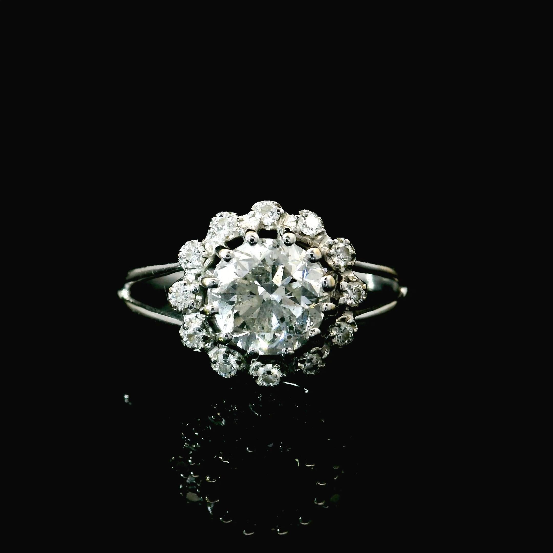 18kt white gold Sapphire Ring
  
  Gold colour & karat: White gold 18kt
  Weight: 2.19 grams
  
  Set with-
  Stone type: Diamond
  Shape: Round
  Carat: 1.00 cts
  Colour: G Colour
  
  Surrounding Stones: Diamonds
 1) White Diamonds
  Carat