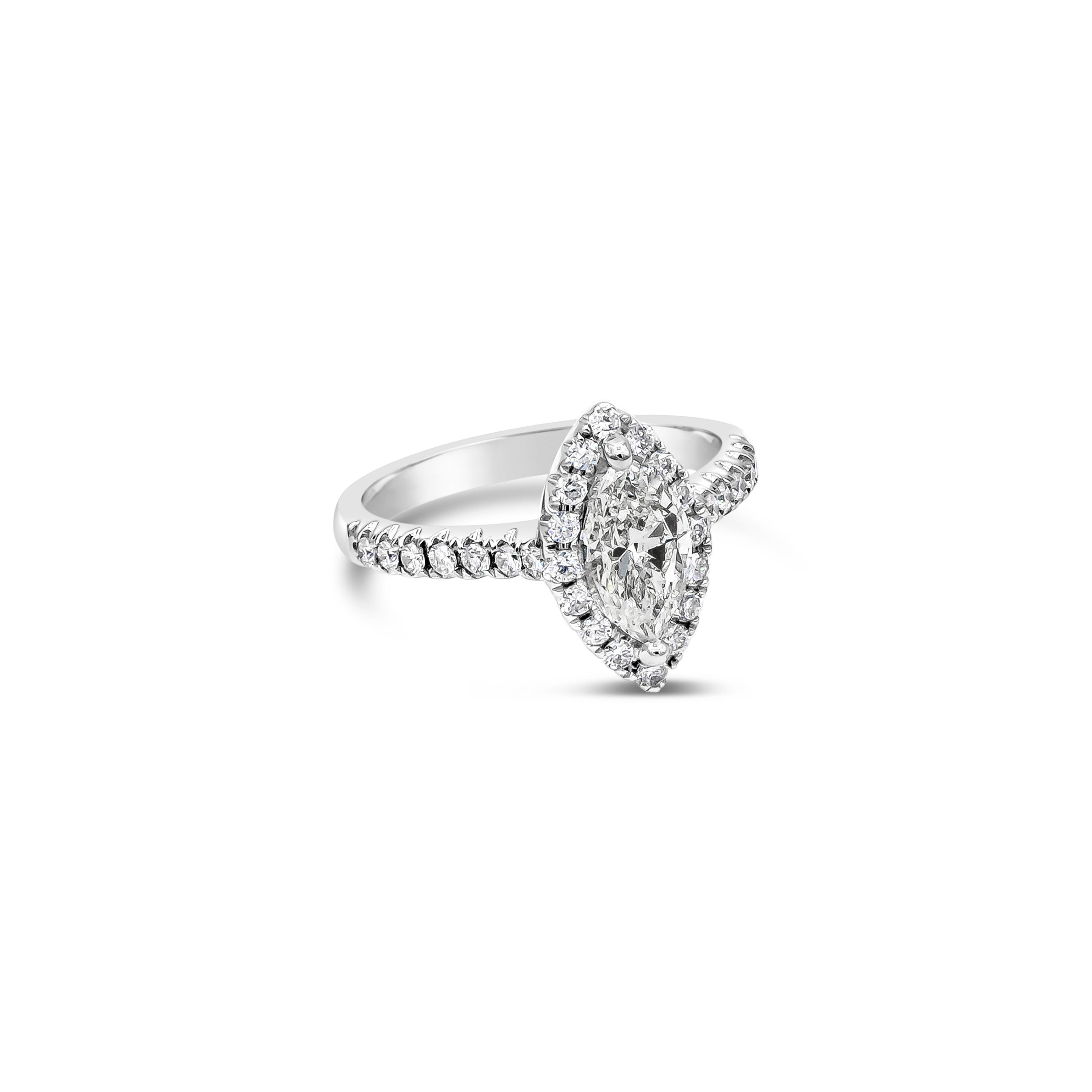 Showcasing a 1.00 carats marquise cut diamond, EGL certified as F color and VS2 in clarity. Surrounded by a single row of round brilliant diamonds in halo setting. Set in a thin diamond encrusted shank half eternity setting, made in 18K white gold.