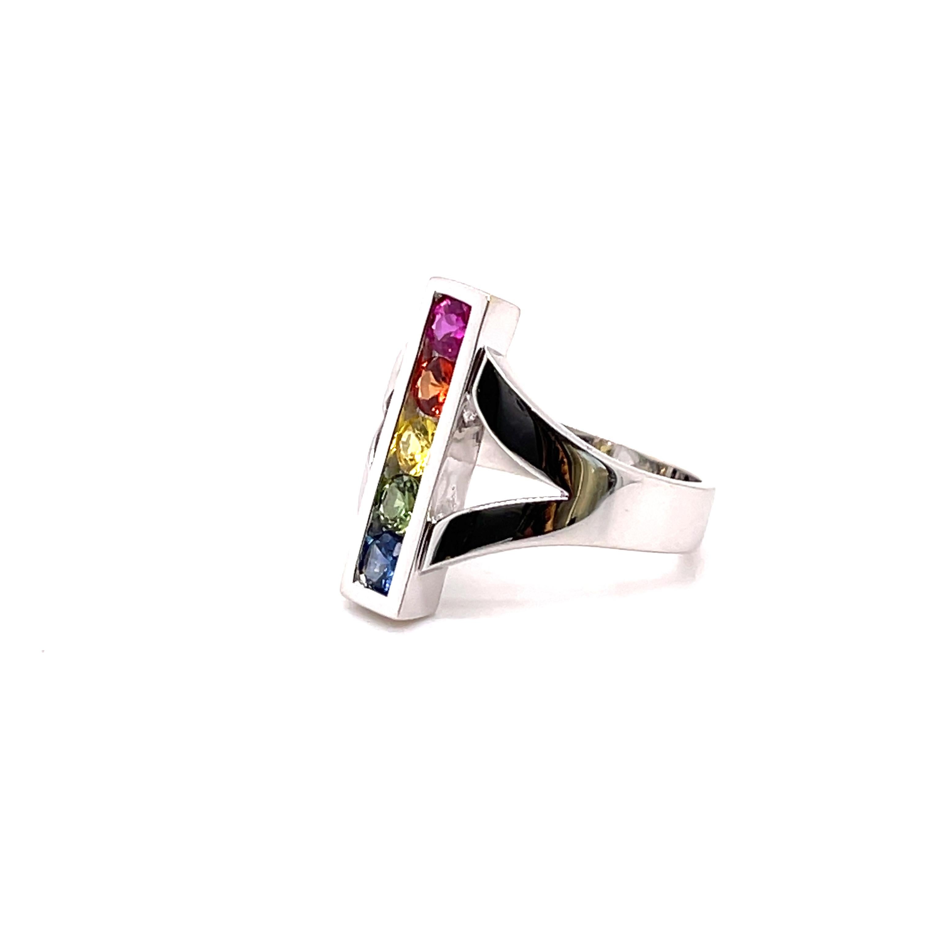 This ring is a different approach to the usual multicolor design. 

A simple design with nine multi-color Sapphires round brilliant cut 3.4 mm with a total weight of 1.00 carats. 
The ring is 19.2 mm wide and the band 3.7 mm.

Done in  18-karat