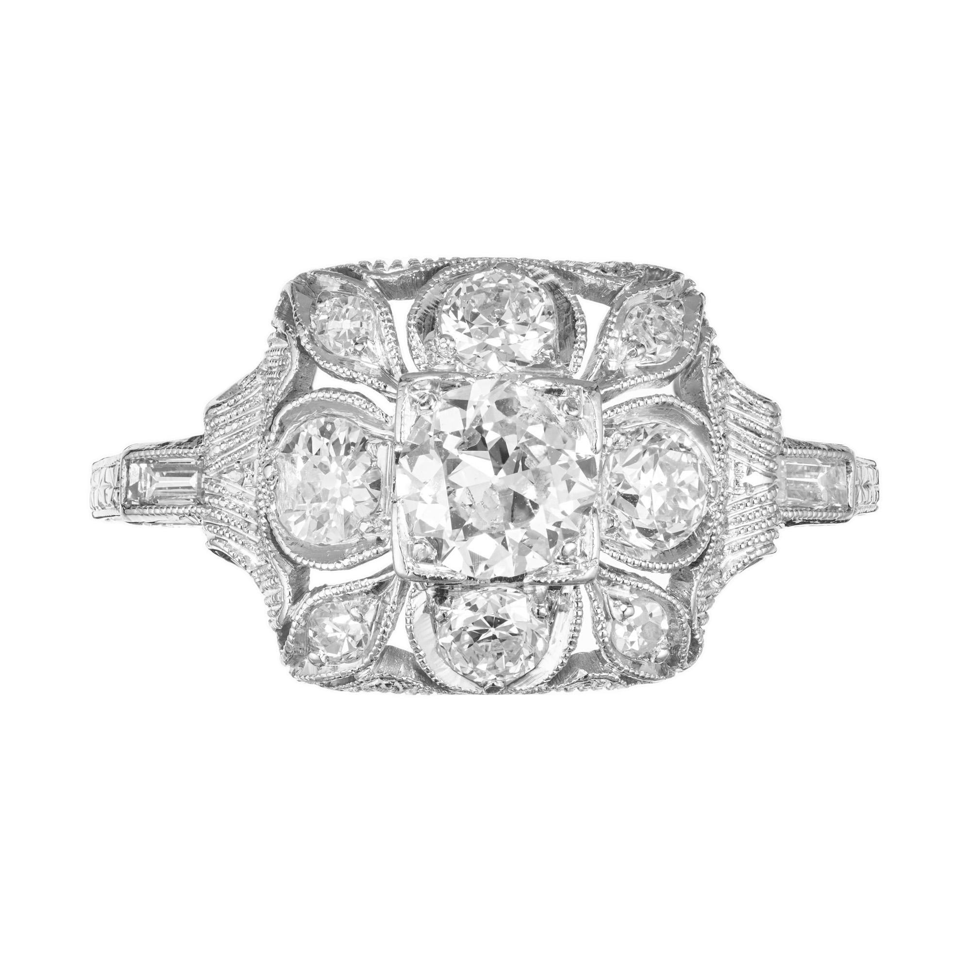 1910 vintage antique diamond engagement ring. A trip back in time, this beautiful open work platinum engagement ring setting has a .50ct Old European center stone accented with 8 Old European cut diamonds and a straight baguette diamond on each