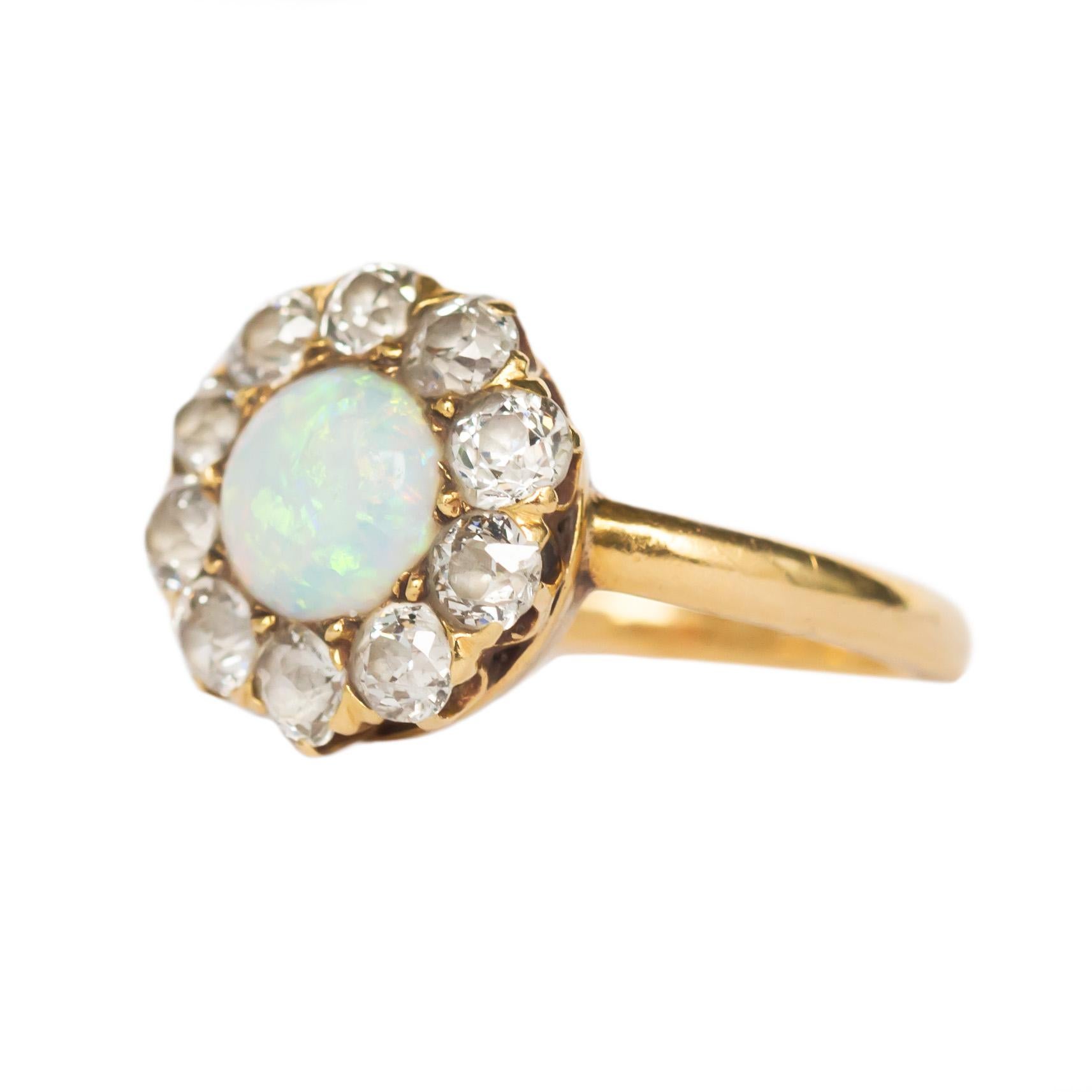 Ring Size: 4.90
Metal Type: 14 karat Yellow Gold 
Weight: 3.9 grams

Color Stone Details: 
Type: Natural Opal 
Shape: Round Cabochon
Carat Weight: 1.00 carat
Color: Rainbow Colors 

Side Stone Details: 
Shape: Antique Cushion
Total Carat Weight: .80