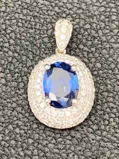 1.00 Carat Oval Cut Sapphire and Diamond Pendant in 18K White Gold