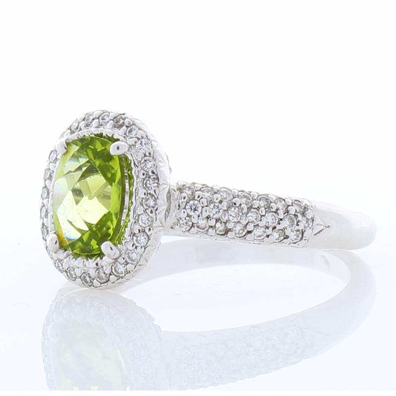 Your friends will be green with envy when they see you wearing this spectacular peridot and diamond ring. It is luxurious, yet unassuming. A gorgeous checkerboard cut 1.0 carat oval lime green peridot delights the eye and adds a vivid pop of unique