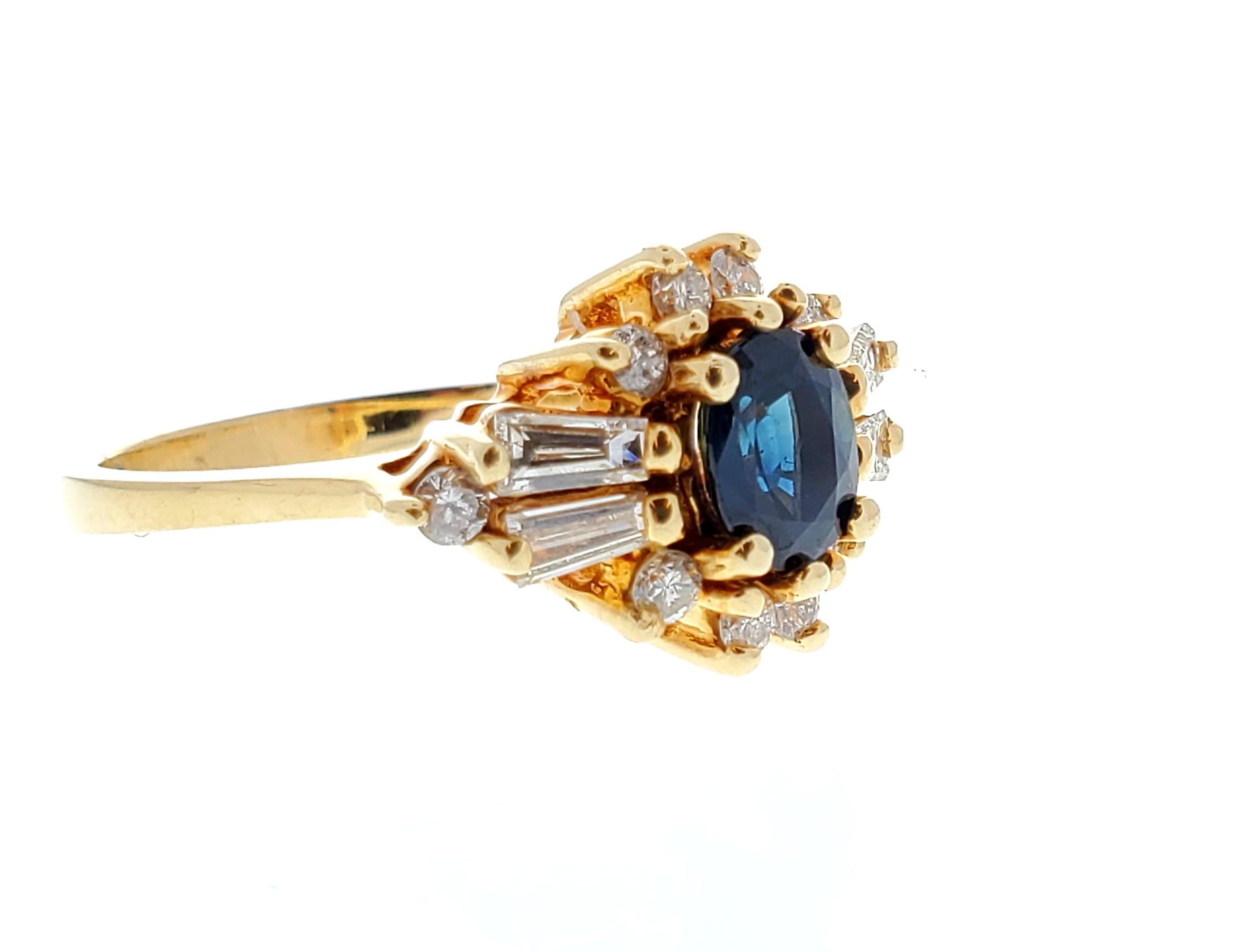 Designed in brightly polished 14 karat yellow gold, this beautiful diamond and sapphire ring features a center-set oval cut 1.00 carat sapphire that exhibits an intense blue color with overall good saturation. This sapphire is complemented 0.70
