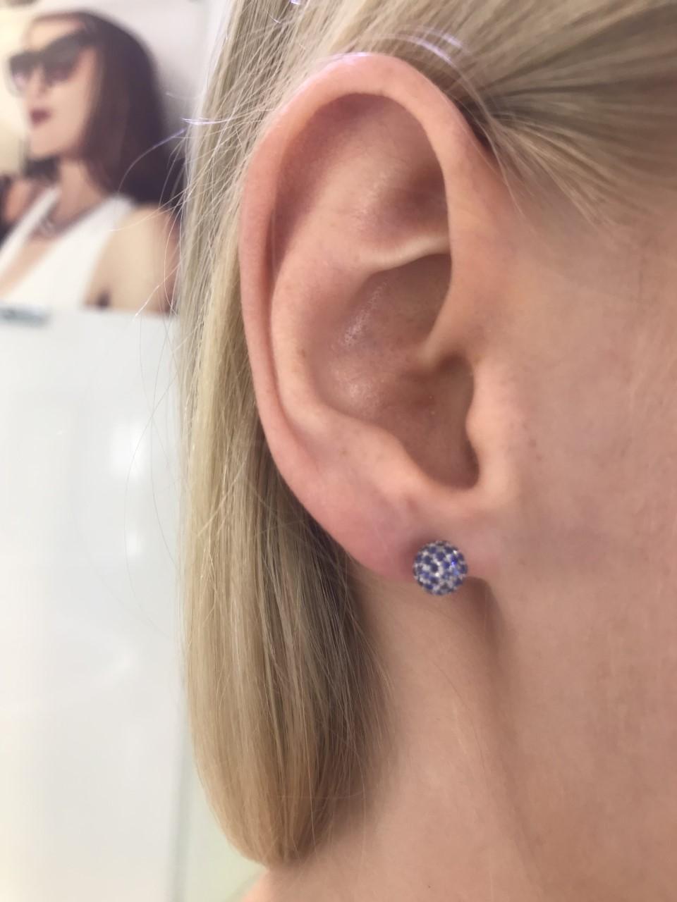These illuminating Pave Set Sapphire earrings are decorated with striking Blue 1.00 Carat Sapphires set in luxurious 18 Karat White Gold. These iconic ball studs are perfect for any occasion. Size 6mm, available in other carat sizes and colors upon