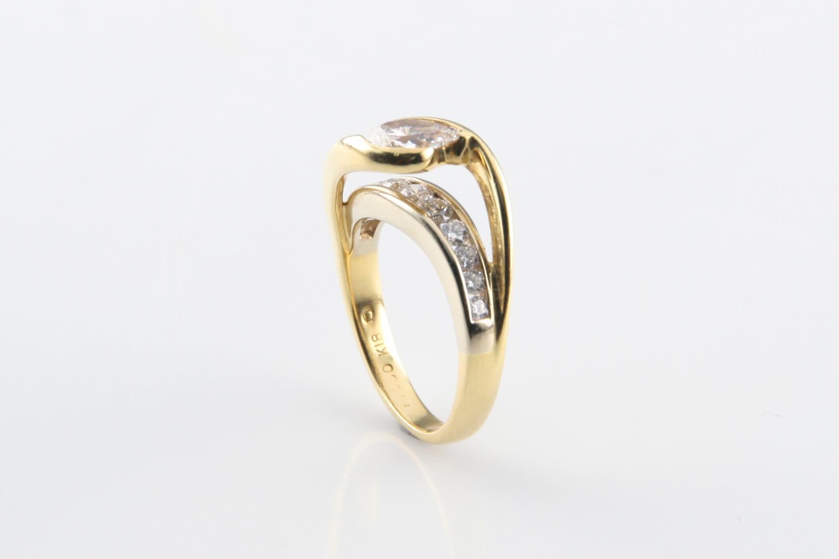 Size 6.25
Bright Finish
Features a Pear Shape Diamond Set Within a Yellow Gold Ribbon Floating Above a Gallery of Round Diamonds, Supported by a 2.5 mm Wide Band
Identified with Markings of 