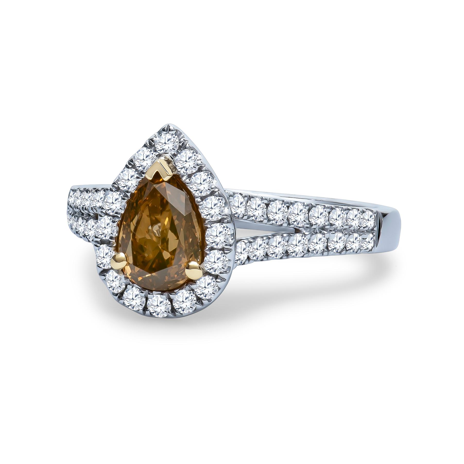 1.00 Carat pear shape fancy brownish, yellow color center diamond with 0.54 carats total in pave-set round diamonds set in an 18K white gold halo engagement ring. Ring size 6.5, may be resized to larger or smaller upon request. 

Diamond Quality: 