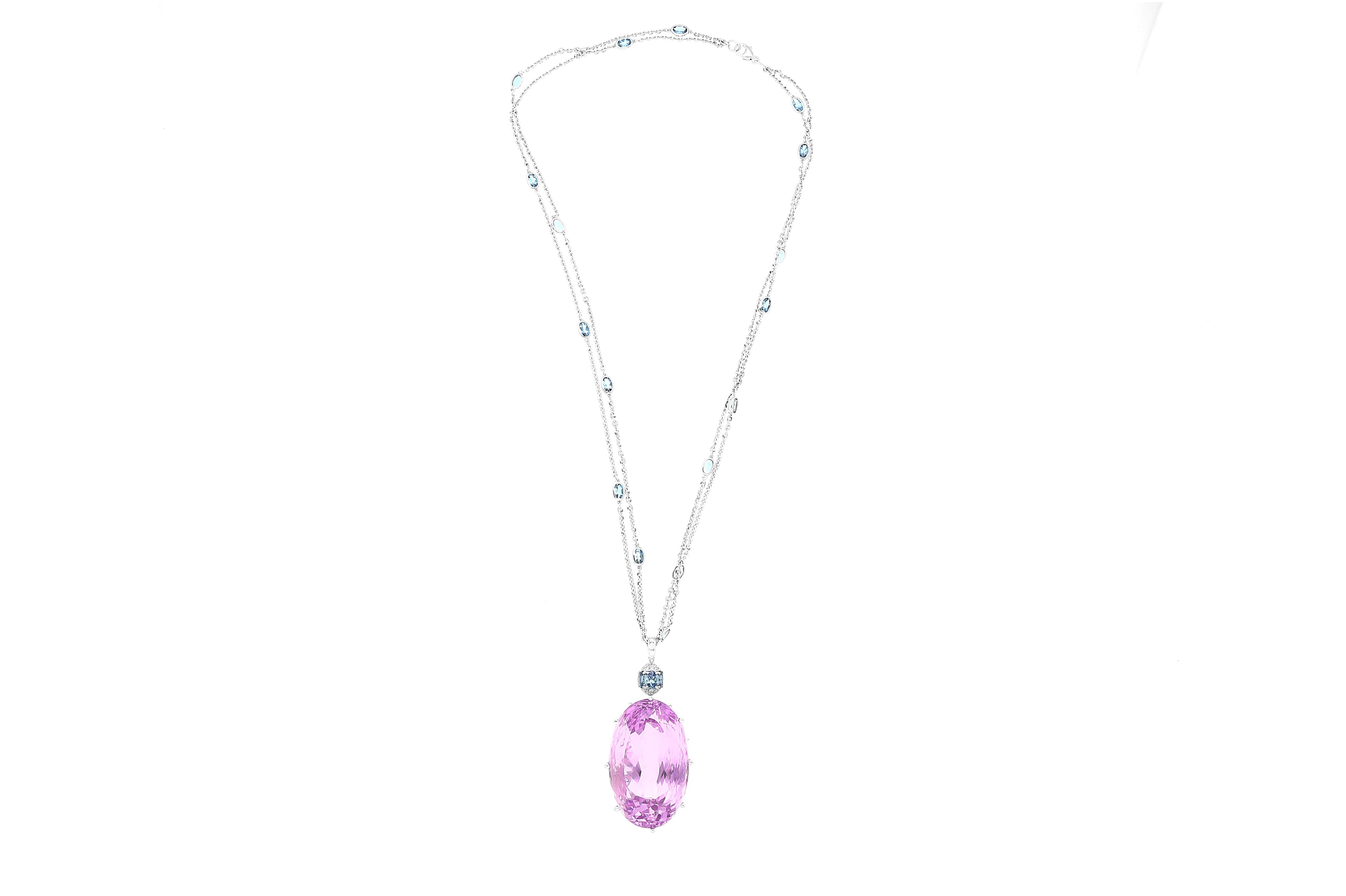 98.66 carat Kunzite and Aquamarine Pendant, an Art Deco masterpiece in 18K White Gold weighing 10.10 grams. This 21-inch pendant features an oval-cut Kunzite (36 x 22.2 MM) in a prong setting, emitting a captivating pink hue.

Surrounding the