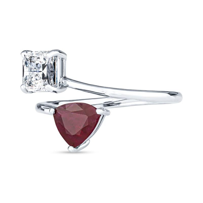 This beautiful and unique toi et moi ring features a 1.00ct radiant cut natural diamond with a 1.16ct trillion cut natural ruby set in 14kt white gold. It is a size 6.5 but can be resized upon request. The toi et moi ring is a very historic ring