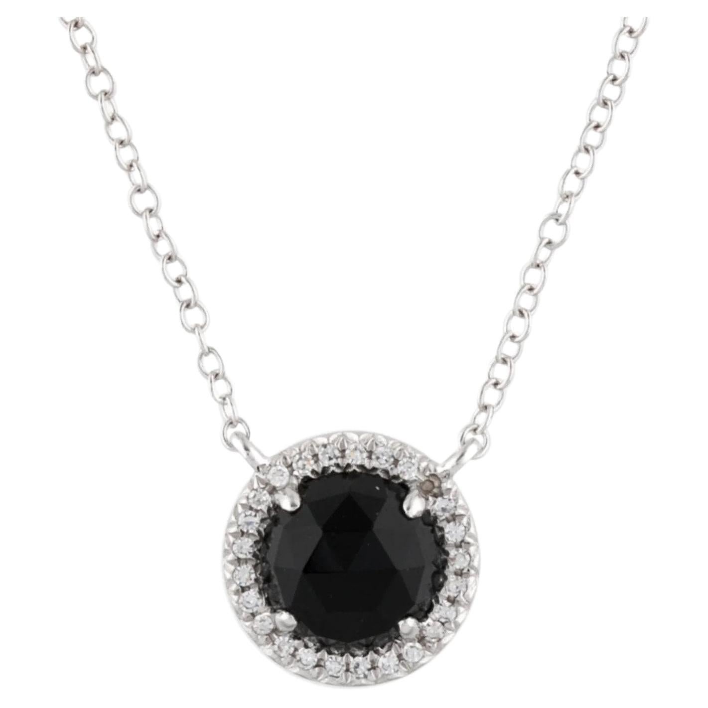 This Black Onyx & Diamond Pendant is a stunning and timeless accessory that can add a touch of glamour and sophistication to any outfit. 

This pendant features a 1.00 Carat Round Black Onyx, with a Diamond Halo comprised of 0.06 Carats of Single