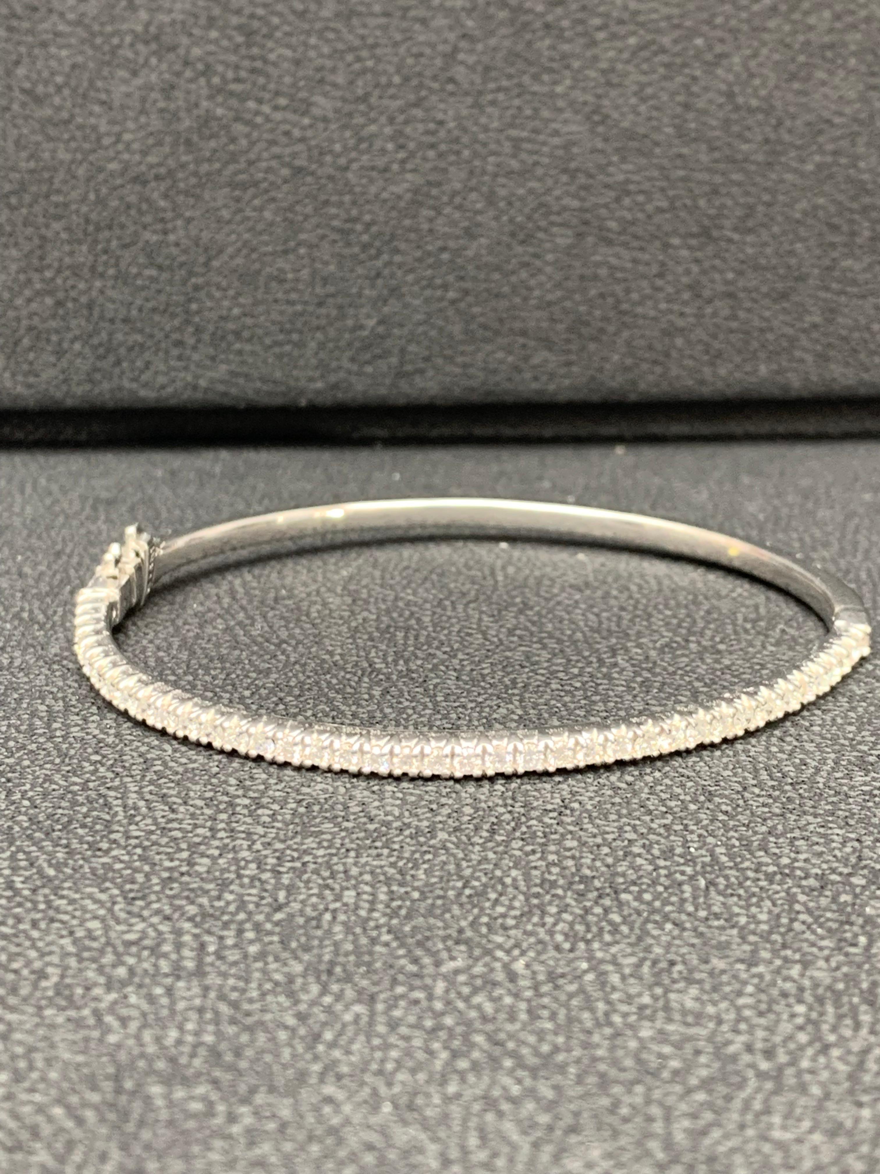 A simple but elegant bangle bracelet set with 40 round cut diamonds weighing 1.00 carats total. Has a clasp to slip and wear the bangle securely. Made in 14k white gold.

Style available in different price ranges. Prices are based on your selection