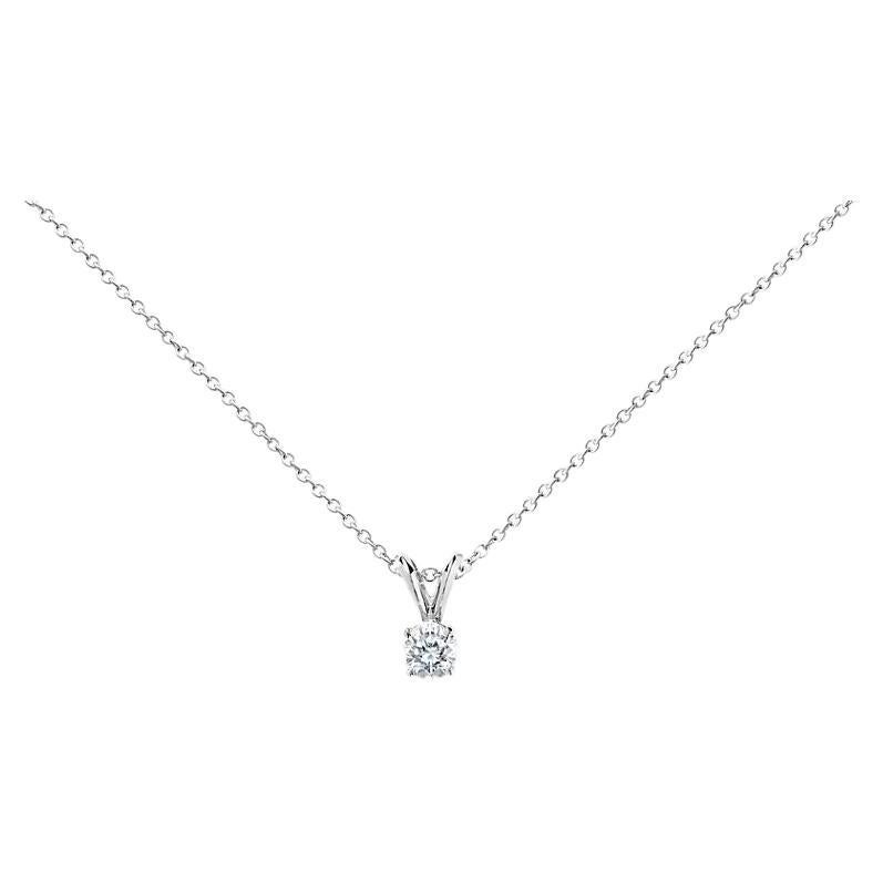 This impressive diamond solitaire pendant is finely crafted in brightly polished 14 karat white gold and features a round shaped 1.00 carat diamond that has I1 clarity, gracefully prong set on a shiny split bail. Ideal as an anniversary or birthday
