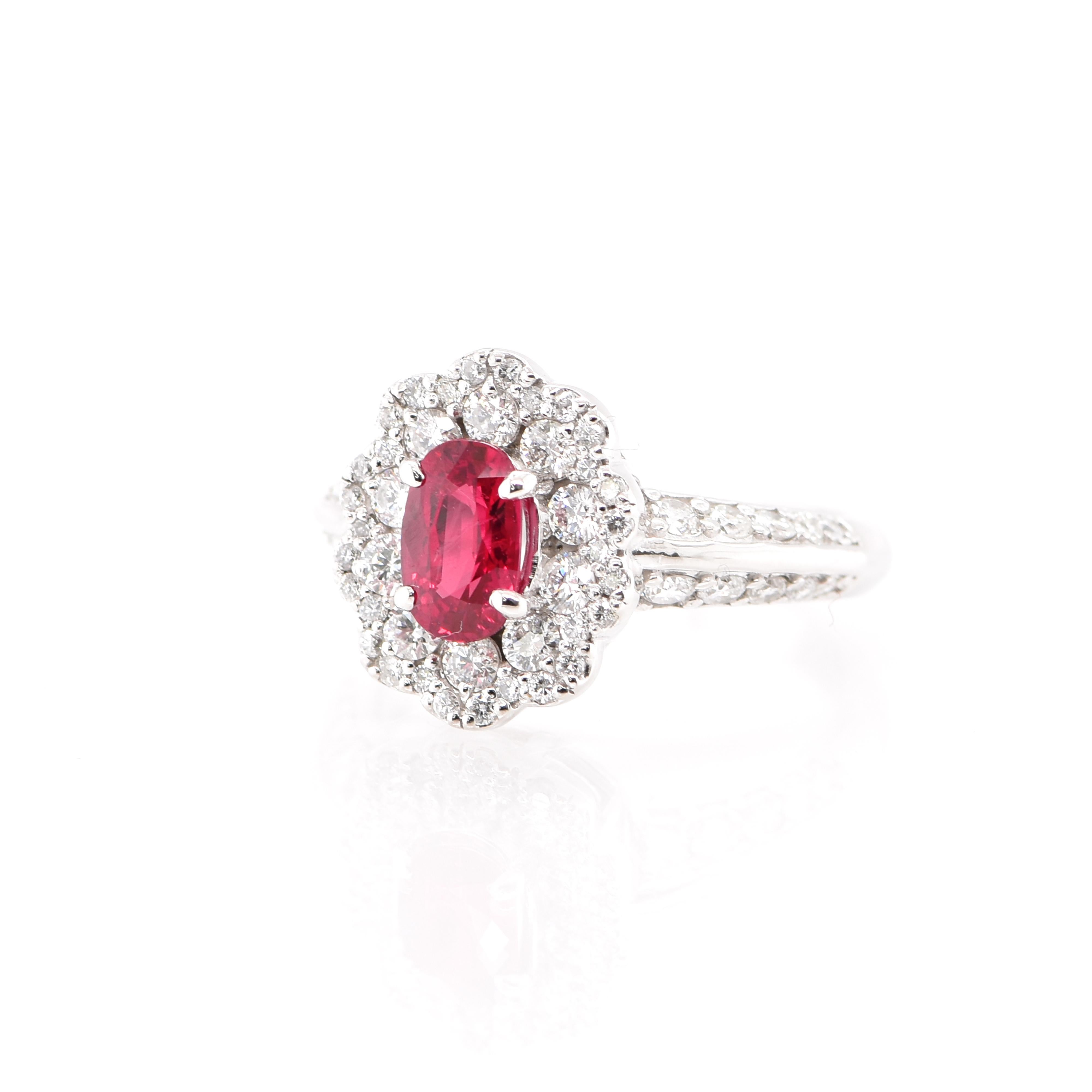 A beautiful Halo Ring featuring a 1.00 Carat Natural Ruby and 0.94 Carats of Diamond Accents set in Platinum. Rubies are referred to as 