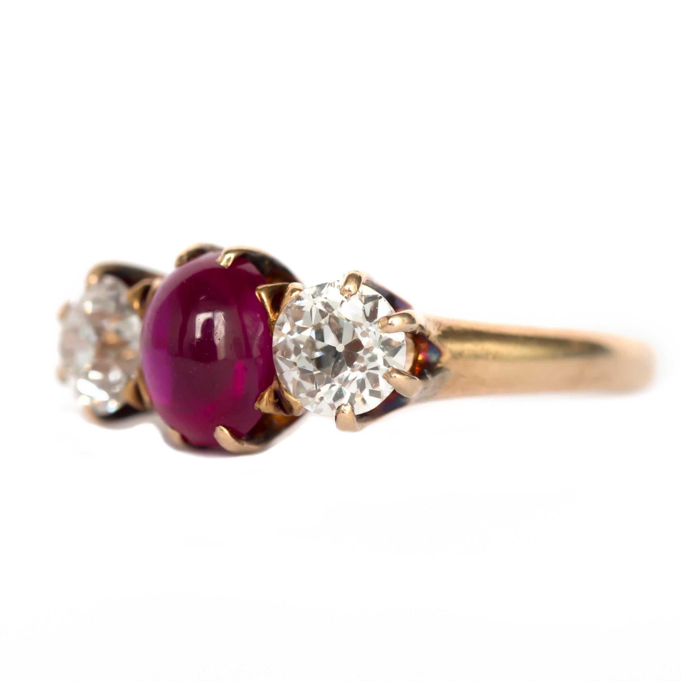 Ring Size: 6
Metal Type: 18 karat Yellow Gold 
Weight: 3.7 grams

Center Diamond Details
Type: Synthetic Ruby
Shape: Cabachon
Carat Weight: 1.00 carat

Side Stone Details: 
Shape: Old European Brilliant 
Total Carat Weight: 1.00 carat
Color: