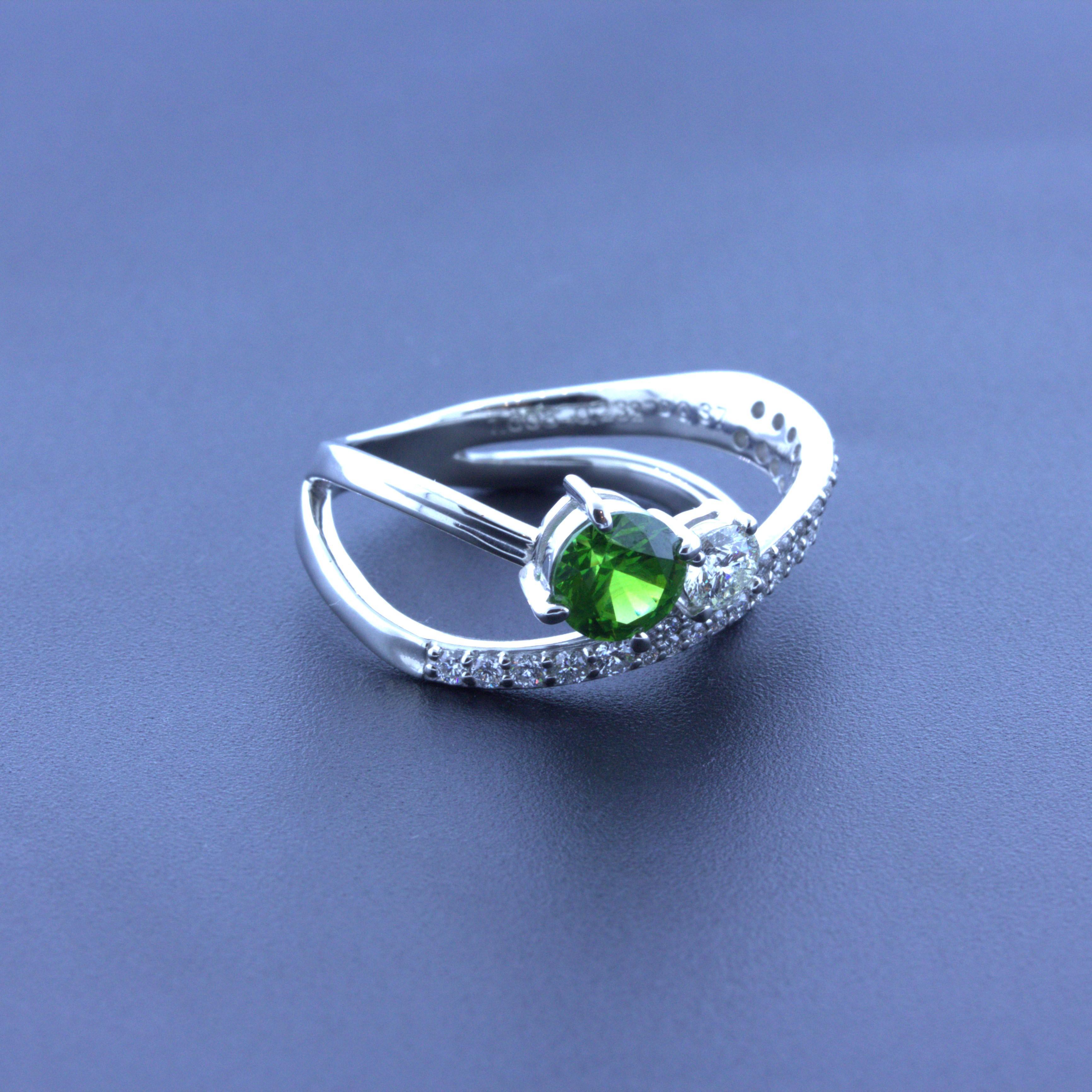 A fun and stylish platinum ring featuring a rare and beautiful demantoid garnet from the Ural Mountains in Russia. Demantoids are known for their intense green color and strong fire and brilliance. This stone is no different, as it has a very rich