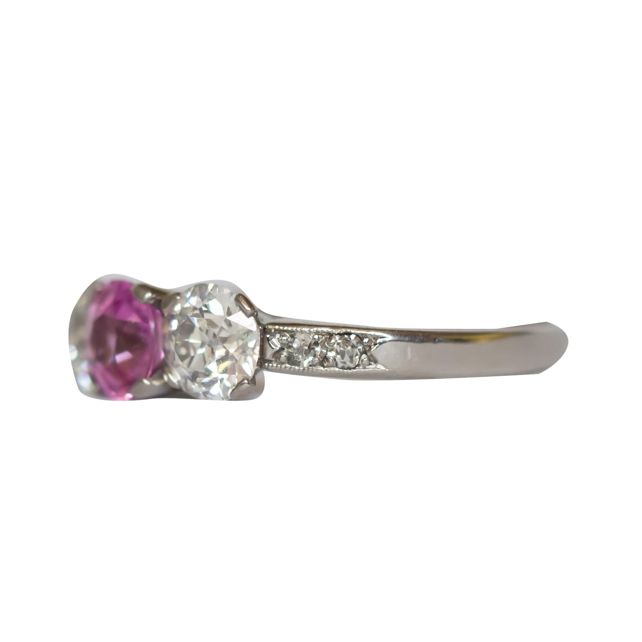 Ring Size: 9.25
Metal Type: Platinum [Hallmarked, and Tested]
Weight:  3 grams

Sapphire Details:
Weight: 1.00 carat
Cut: Old European Brilliant
Color: Pink, Unheated
Clarity: VS


Diamond Details:
Weight: 1.35 carat, total weight (2 stones)
Cut: