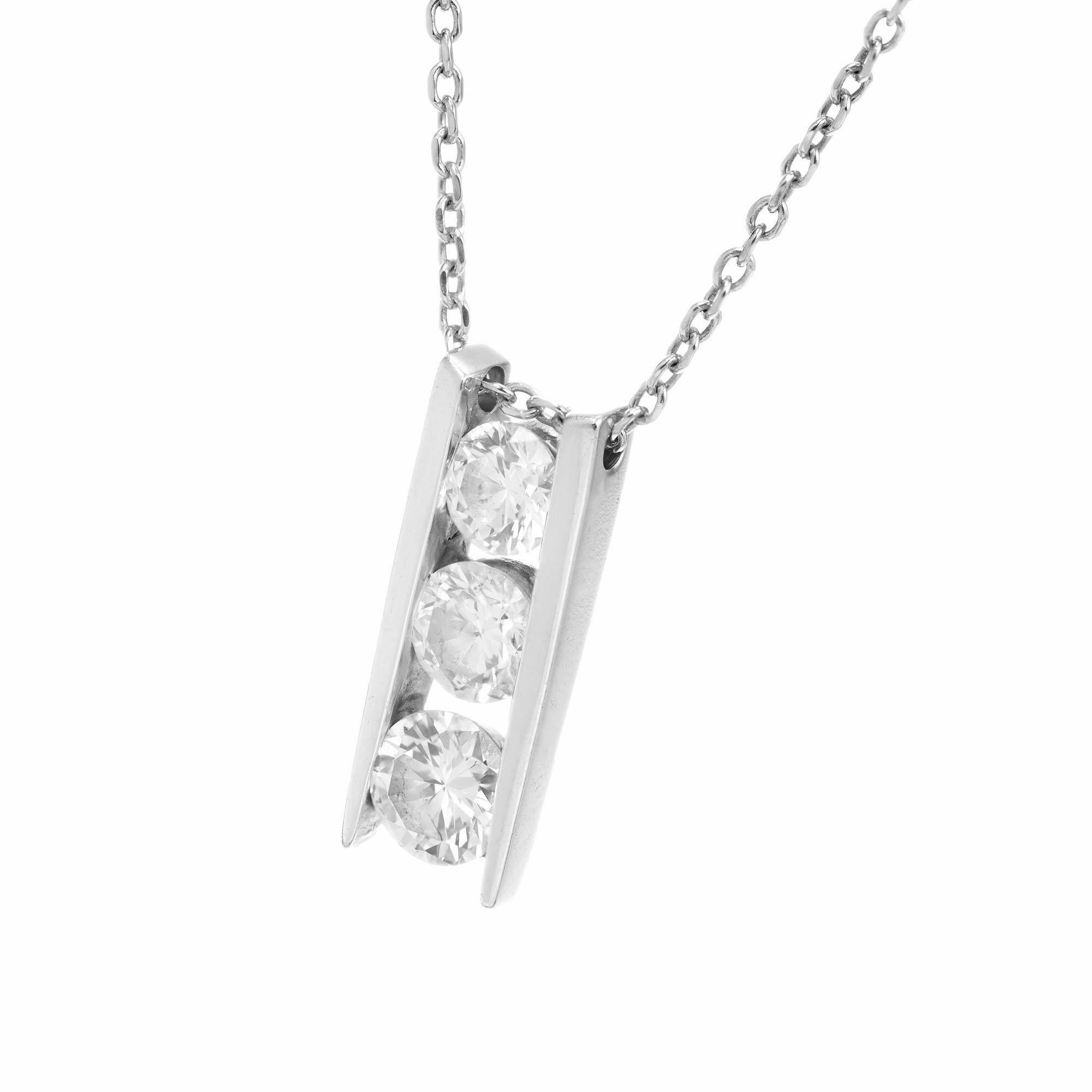 Simple three stone open ladder channel set brilliant cut diamond pendant, in 14k white gold with 14k white gold 20 inch cable chain.  

3 round brilliant cut diamonds, H-I SI approx. 1.00cts
14k white gold 
Stamped: 14k
Hallmark: J
3.1 grams
Top to