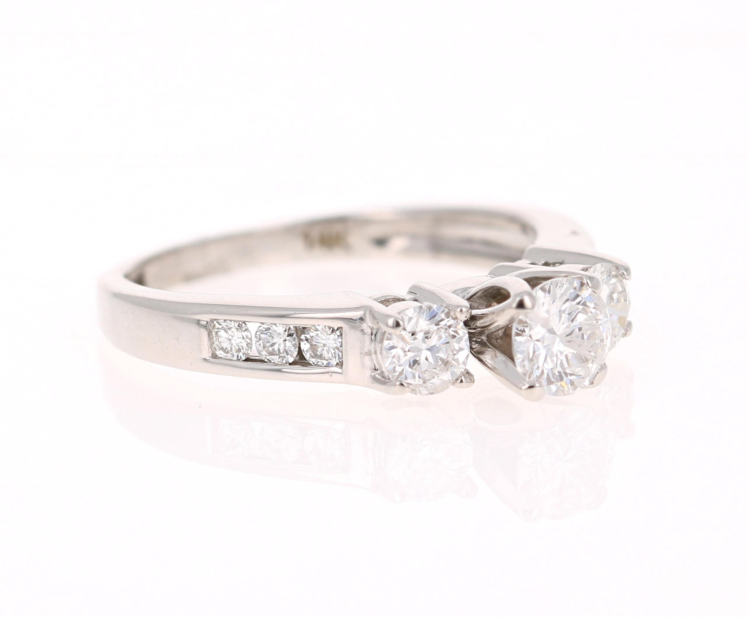 A classic 3-stone Diamond ring set in 14 Karat White Gold. A beautiful promise, engagement or wedding ring. 

There are 9 Round Cut Diamonds that weigh 1.00 Carat. (SI-F)

It is set in 14K White Gold and weighs approximately 3.8 grams.
 
The ring is