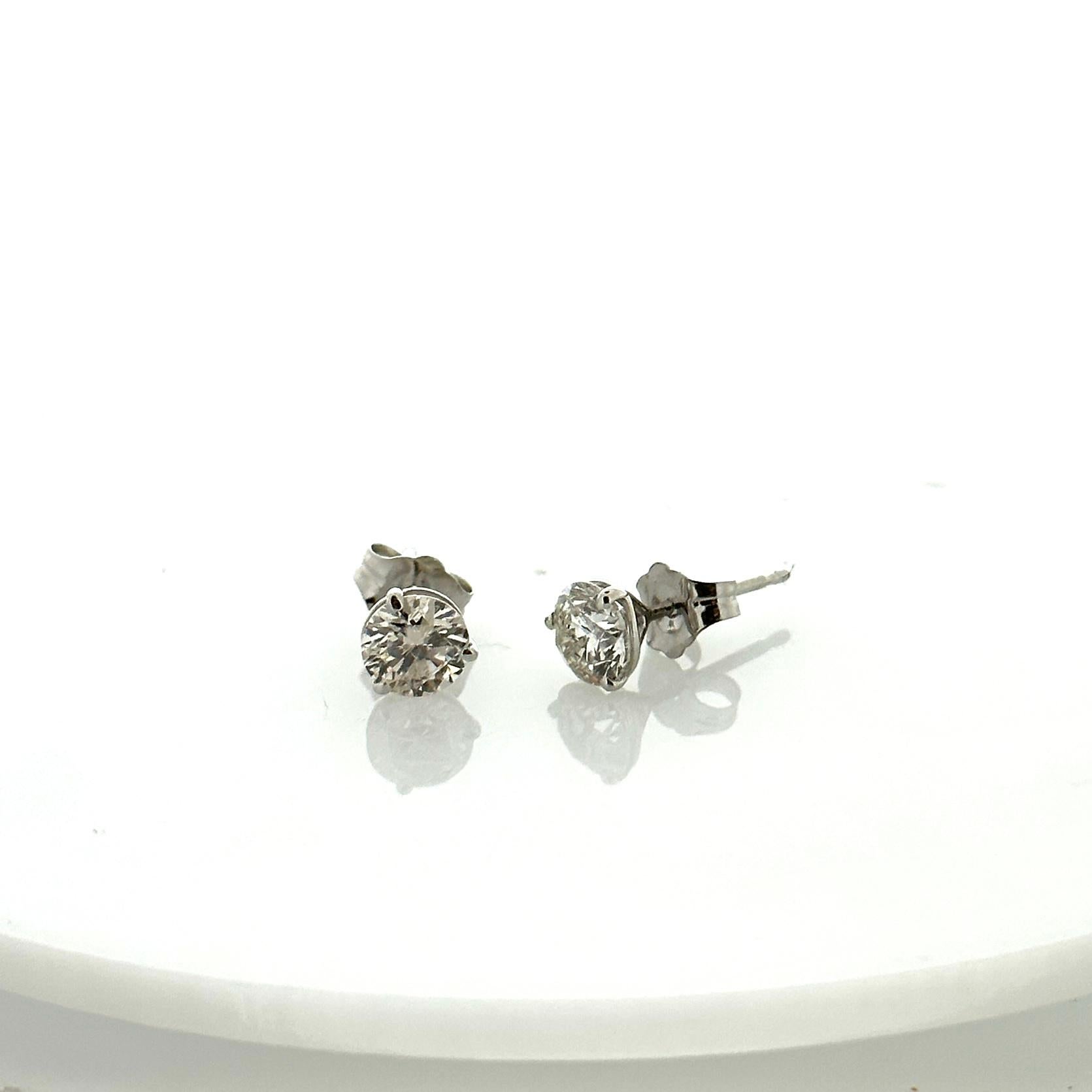 Stunning 14 Karat white gold handmade earrings featuring 2 round brilliant cut diamonds weighing 1.00 carat total I-J color and SI1 clarity. These gorgeous earrings are classic and timelessly elegant.