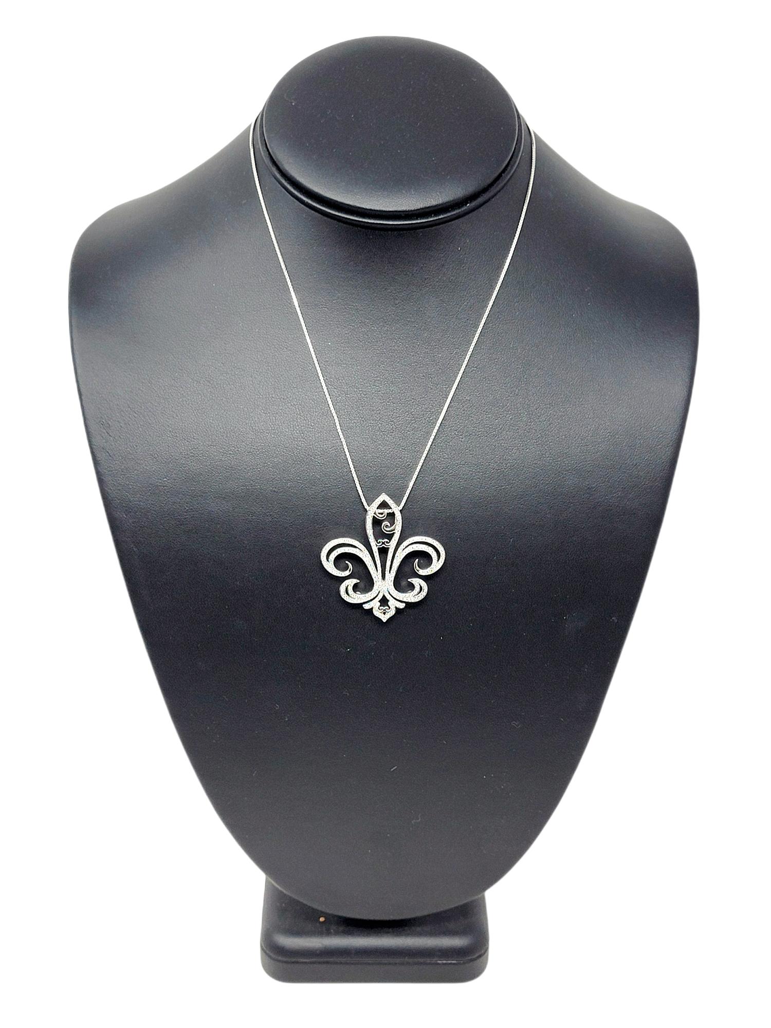 Lovely white gold and pave diamond fleur-de-lis pendant. Featuring delicate features and intricate detail, the pretty piece sparkles beautifully on the neck. 228 round brilliant pave diamonds are set throughout the pendant, offering a brilliant