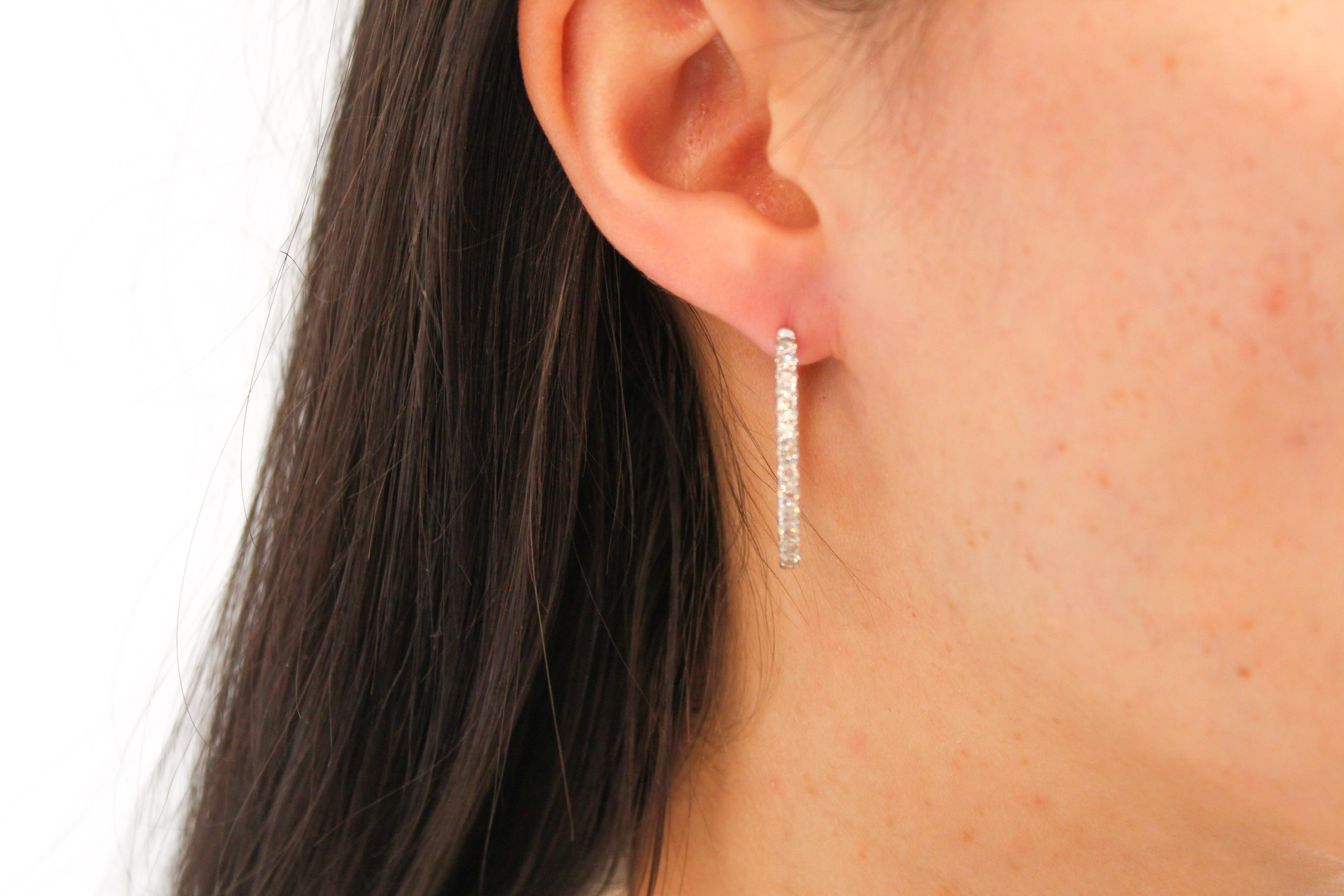 Nothing says luxury like an incredible pair of diamond oval hoop earrings. These stunning brightly polished 14 karat rose gold outside oval-shaped hoop earrings feature a total of 24 round brilliant cut diamonds totaling 1.00 carats are prong set on