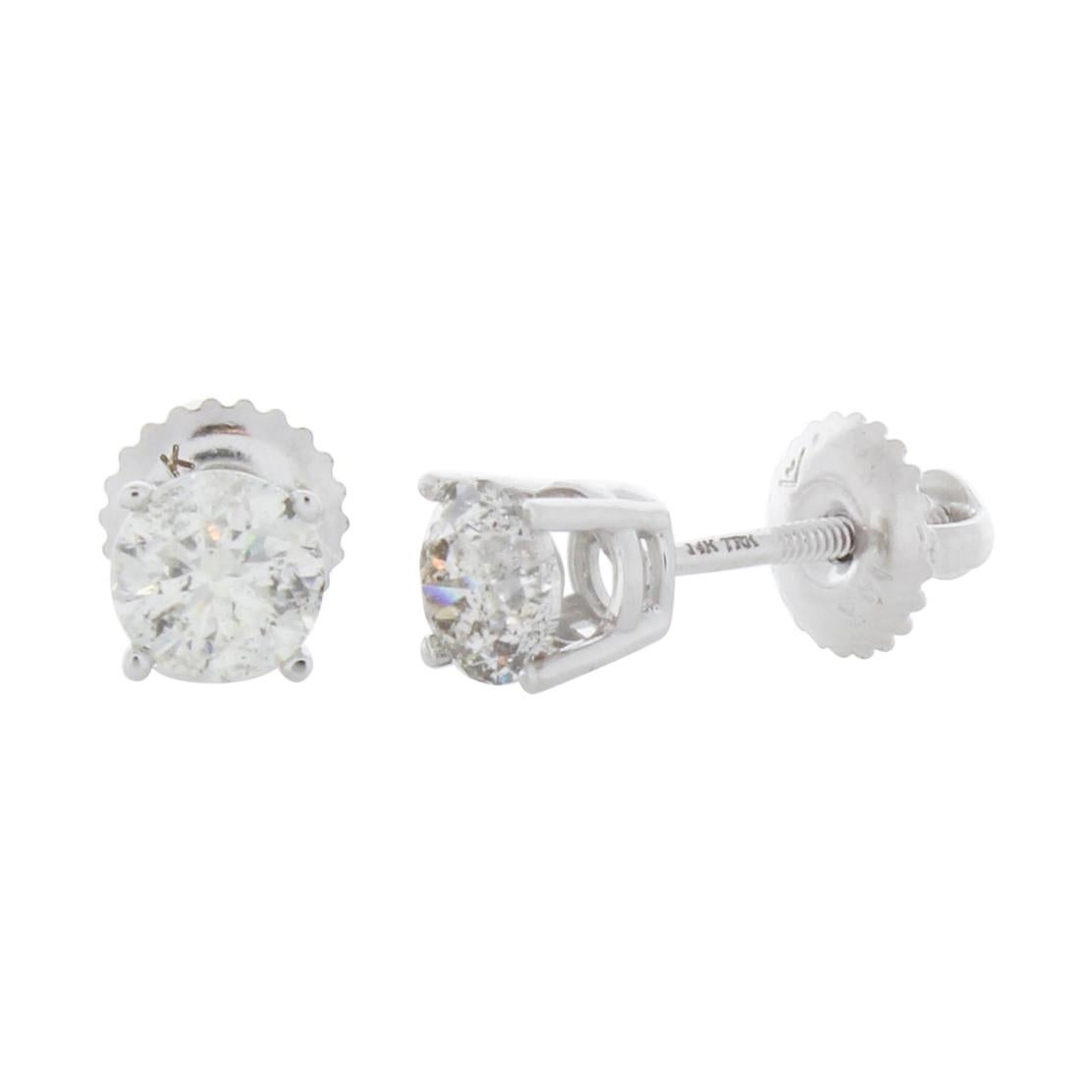 Stunning 14 Karat white gold handmade earrings featuring 2 round brilliant cut diamonds weighing 1.00 carat total I-J color and I1 clarity. The stunning earrings measure 5mm in diameter, these gorgeous earrings are classic and timelessly elegant.