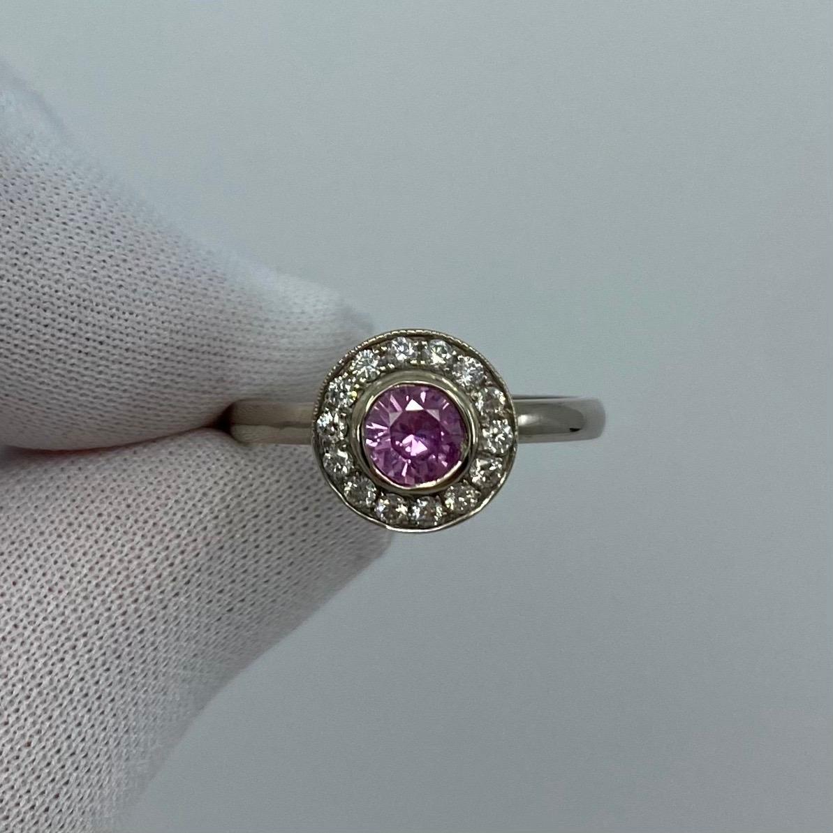 Round Bright Pink Sapphire & Diamond 18k White Gold Halo Ring.

A stunning 18k white gold pink sapphire halo ring with accent diamonds.
0.85 Carat centre sapphire with a beautiful pink colour, excellent round cut and clarity, very clean