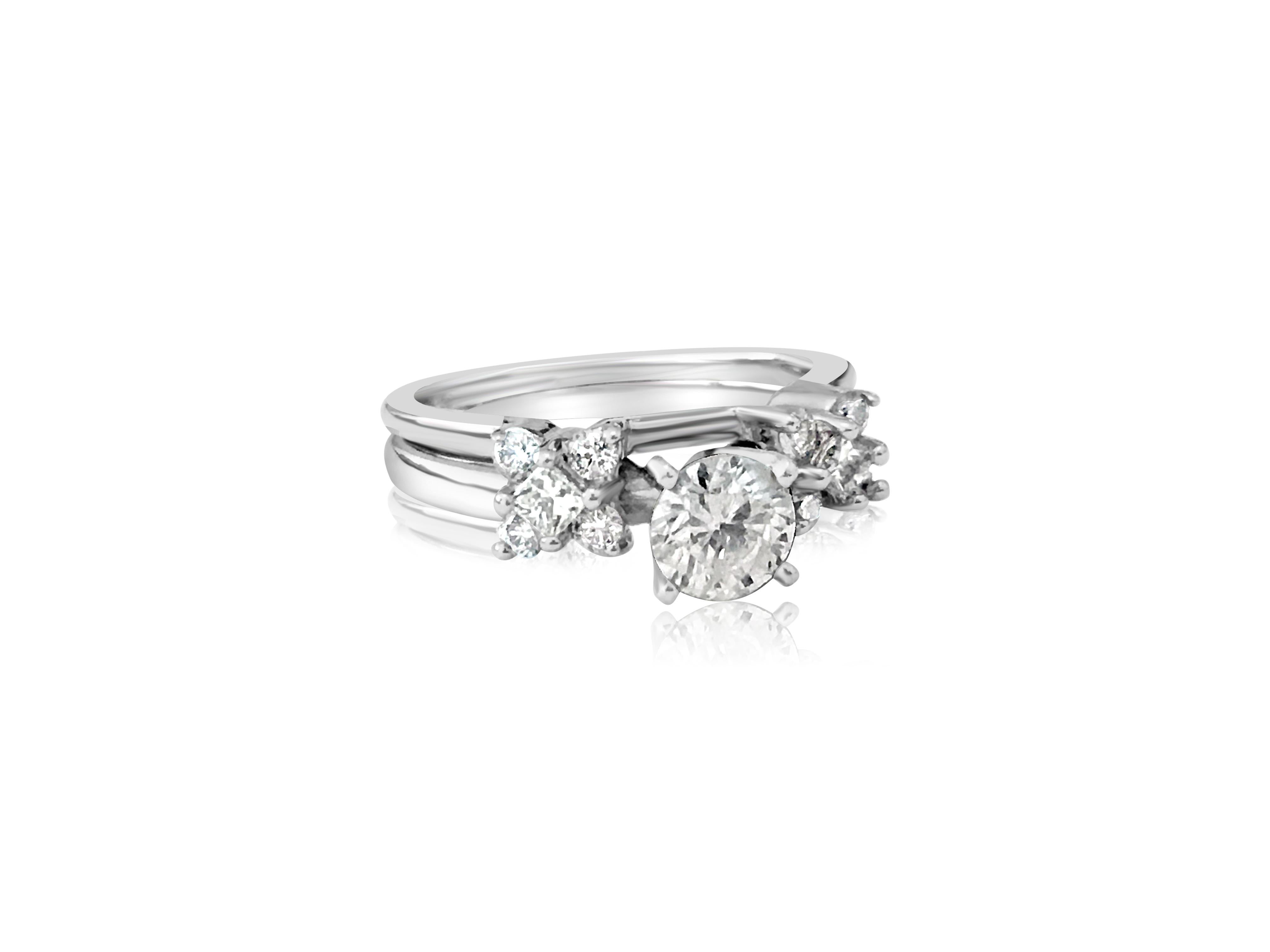 This stunning engagement ring is crafted from 14K white gold and features a 0.60-carat center diamond with I1 clarity and G color. The round brilliant cut diamond is set in prongs, complemented by 0.40 carats of side diamonds, all with VS clarity
