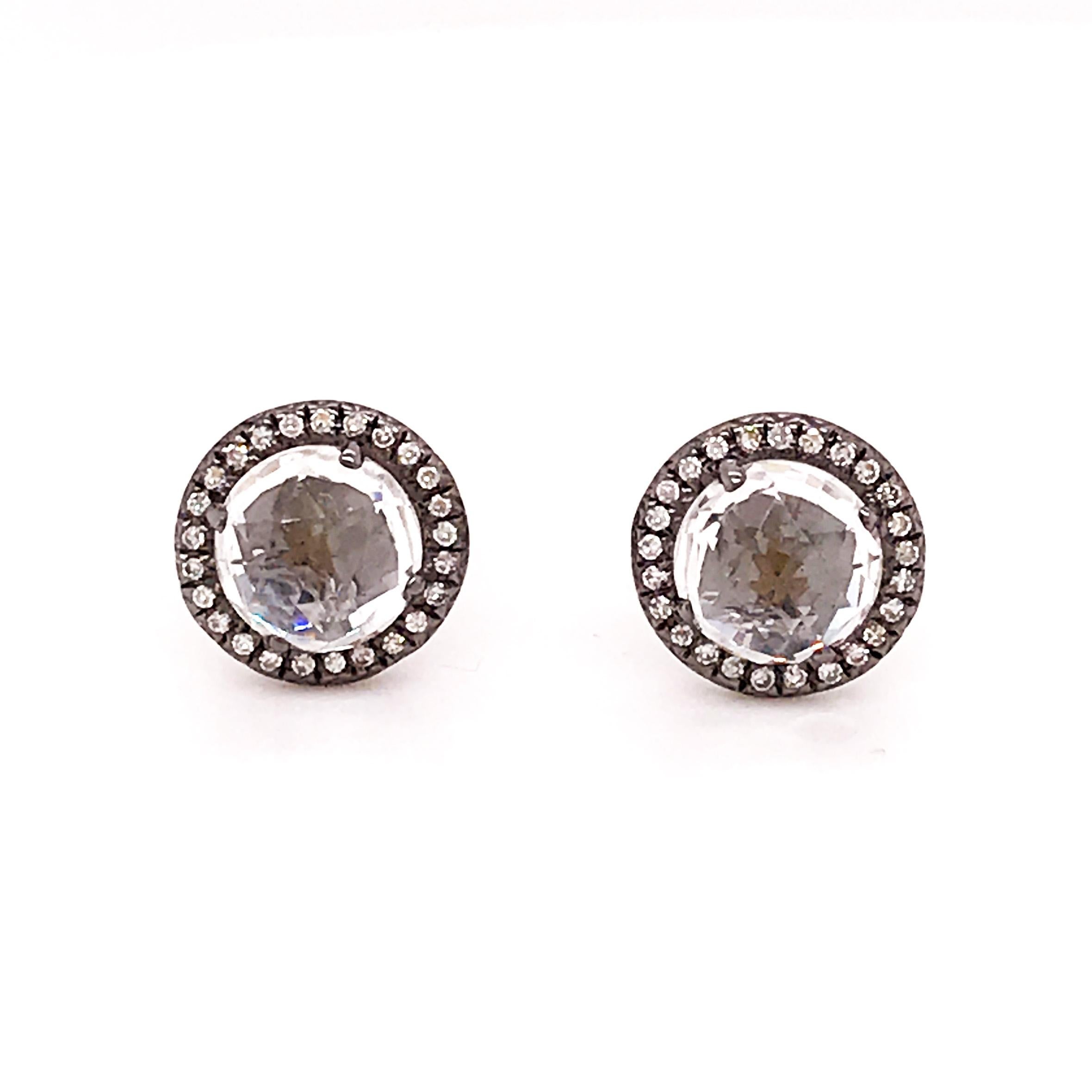 The white topaz and diamond stud earrings are a one of a kind jewelry accessory. With a uniquely cut white topaz gemstones set in the center, this gemstone has a faceted cut that reflects light from every angle. Encased in a black-white gold diamond