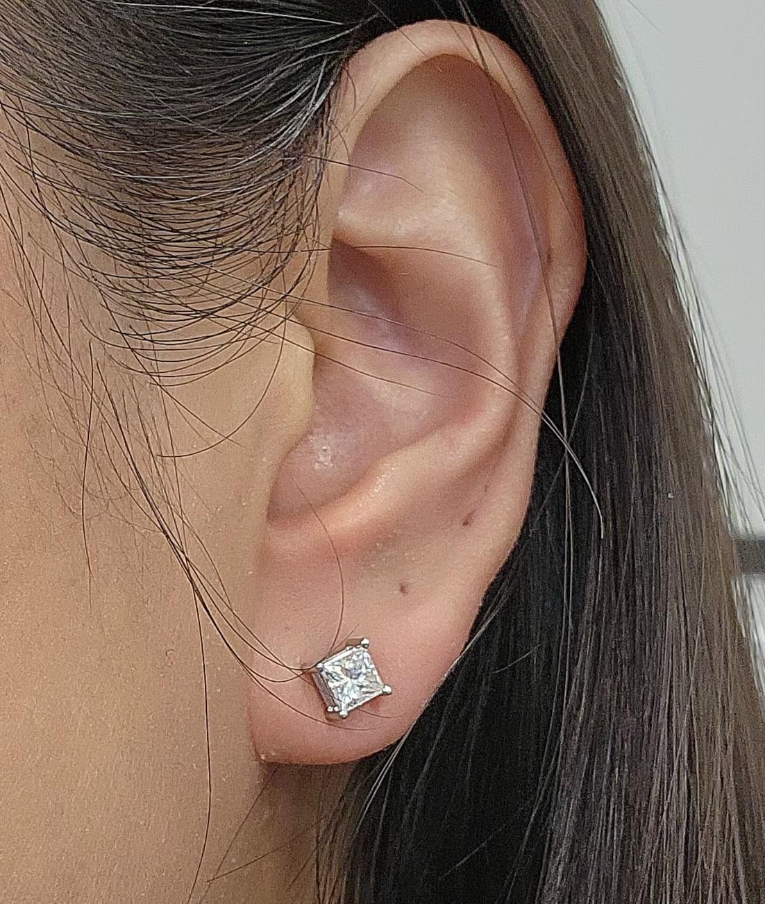 These exquisite stud earrings feature approximately 1.00 ct princess-cut white diamonds. The diamonds are E/F in color and VS2/SI1 in clarity, set in 14k white gold. Crafted in the United States, these modern earrings are a timeless addition to any