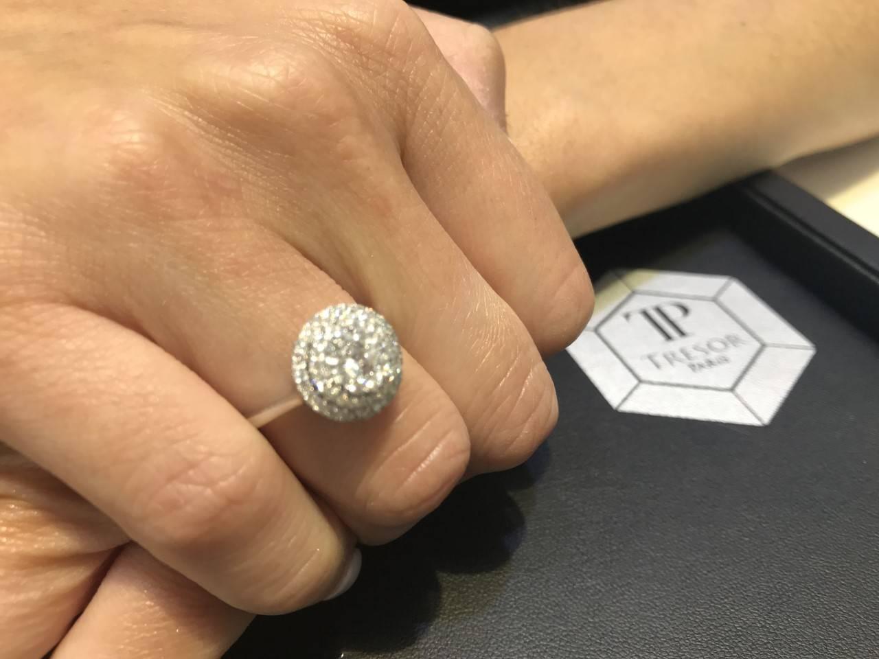 This Beautiful total weight of 1.00 Carat Cluster ring includes Double Halo 0.85 Carat White Round Cut Diamonds and 0.15 White Round Cut Diamond as a main stone. Set in 18 Karat White Gold and color H clarity SI1. Ring size UK - N, US - 7 1/2.