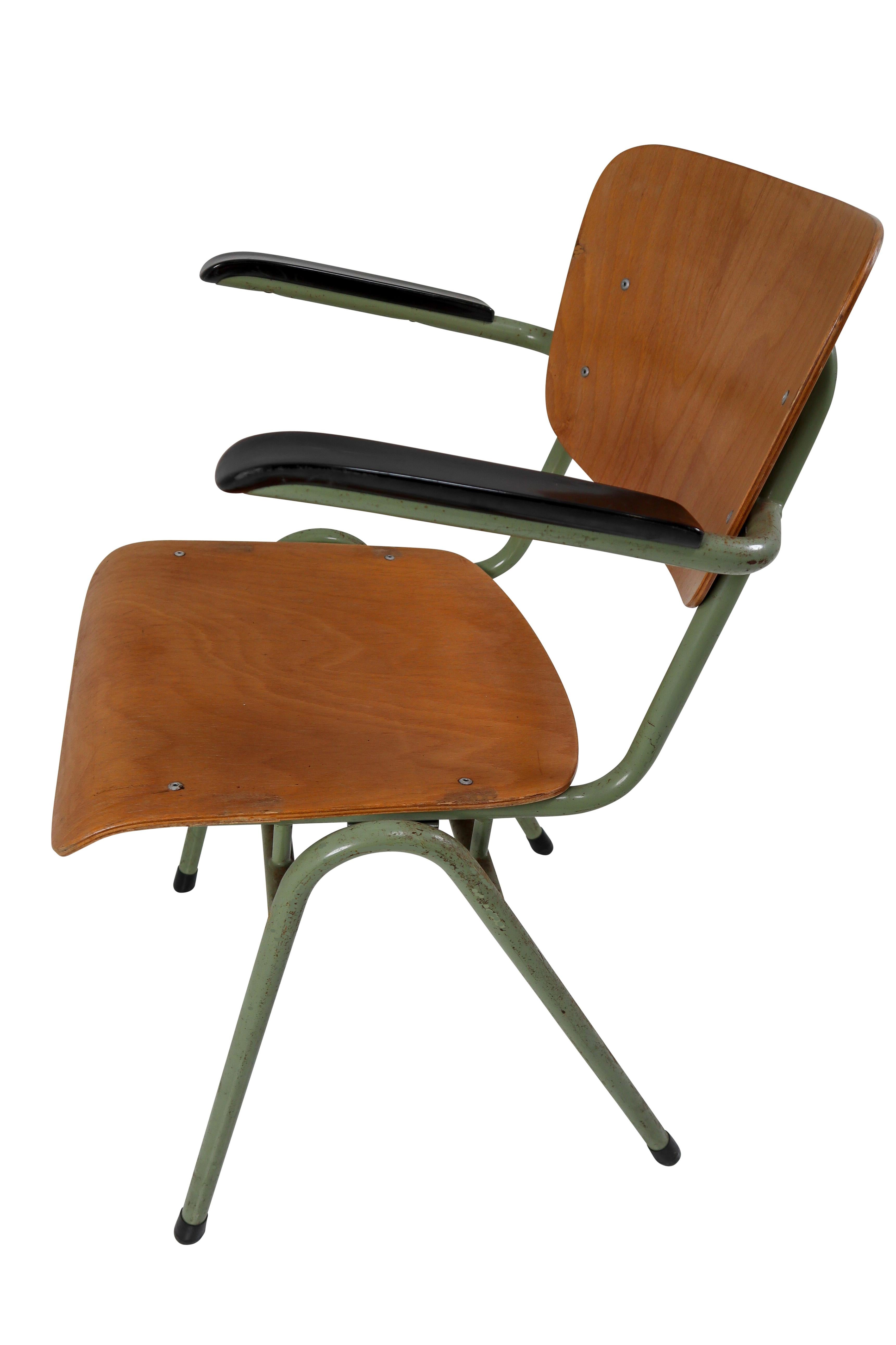 Crazy set of 100 x comfortable industrial plywood chairs, produced in Holland in the 1960s. These Dutch design chairs have a patinated green tubular metal frame and beautifully curved plywood seats. All with armrests made from bakelite and also