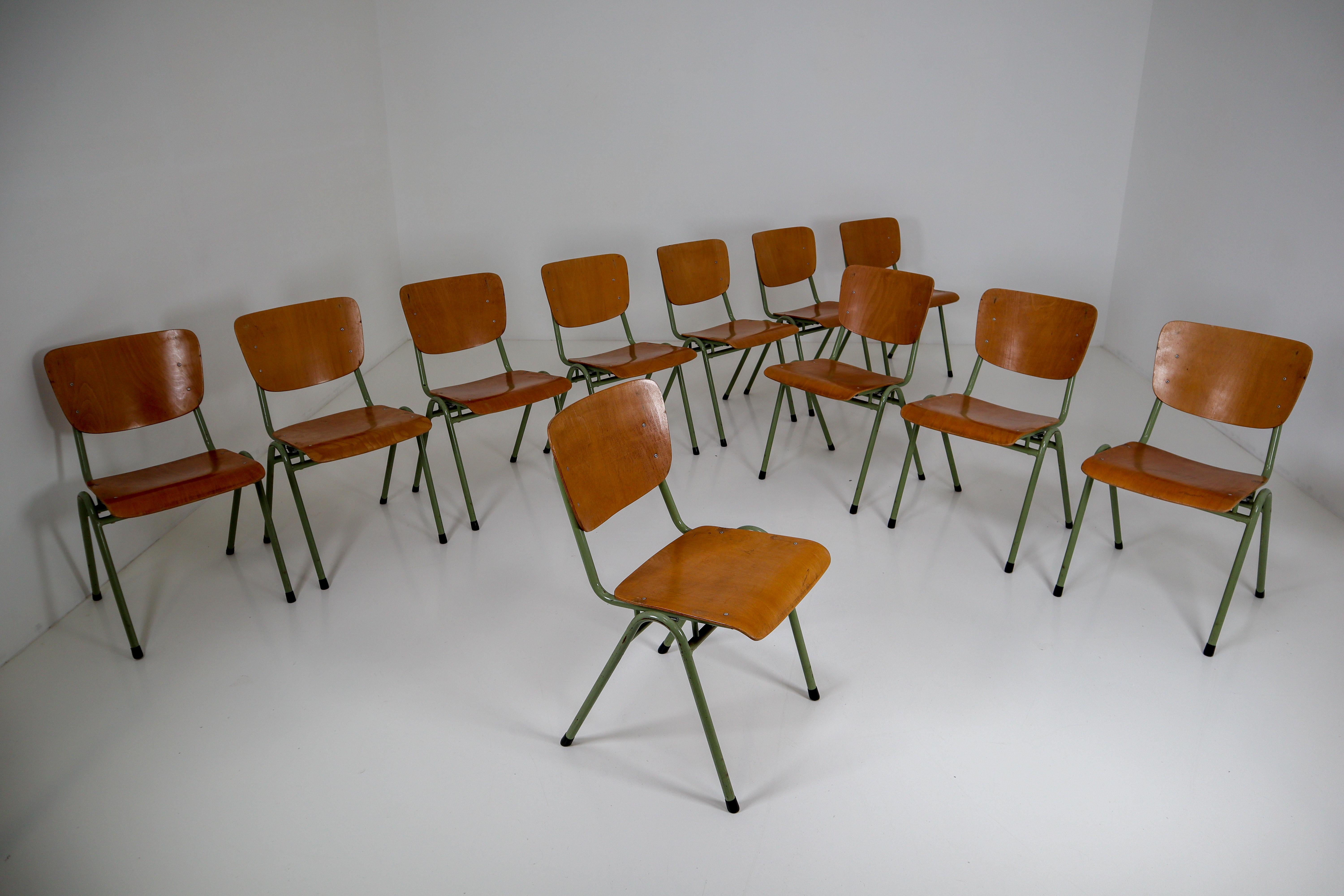 Crazy set of 100 x comfortable industrial plywood chairs, produced in Holland in the 1960s. These Dutch design chairs have a patinated green tubular metal frame and beautifully curved plywood seats. Minor wear consistent with age and use, very nice