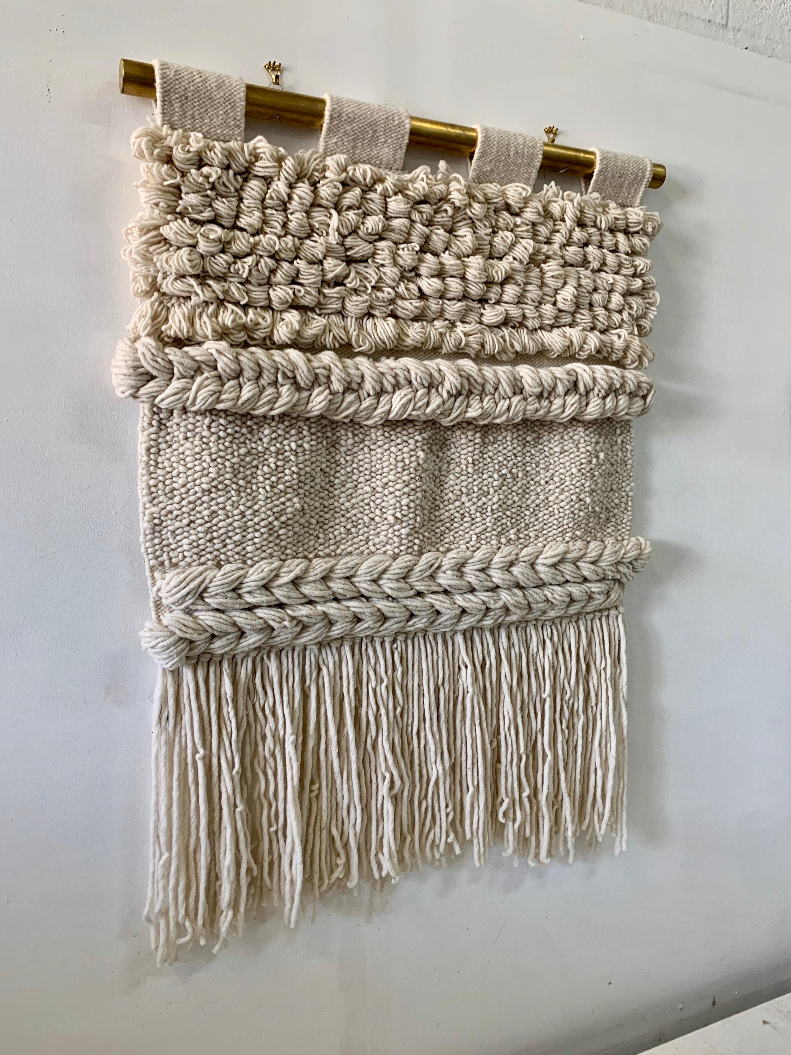 All natural beach style tapestry in non-died wool textile, woven by hand in this intricate and elegant design. The brass hanging rod has been custom designed for this piece for the best possible displaying and hanging. Details include thick loops